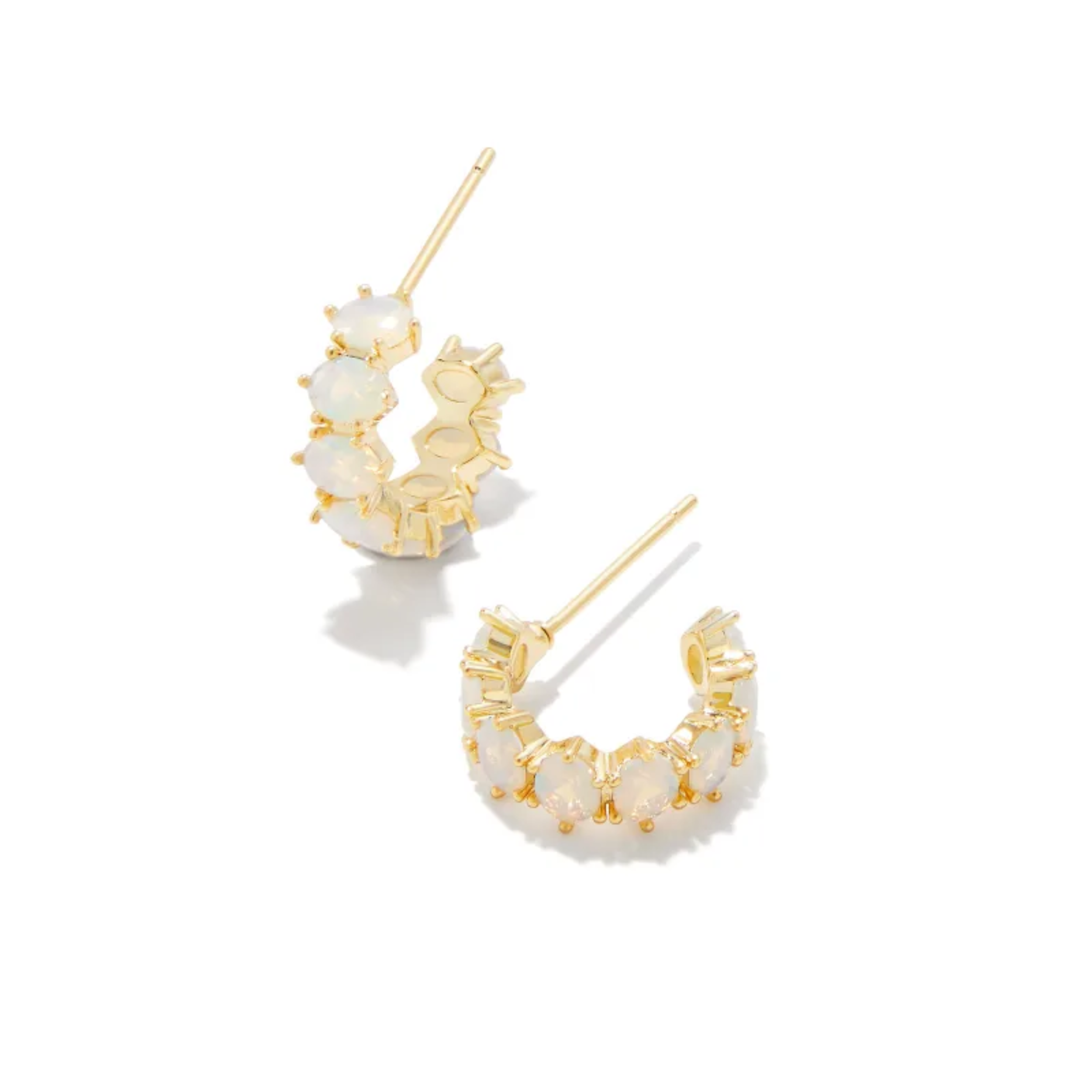 These Cailin Gold Crystal Huggie Earrings in Champagne Opal Crystal by Kendra Scott are pictured on a white background.