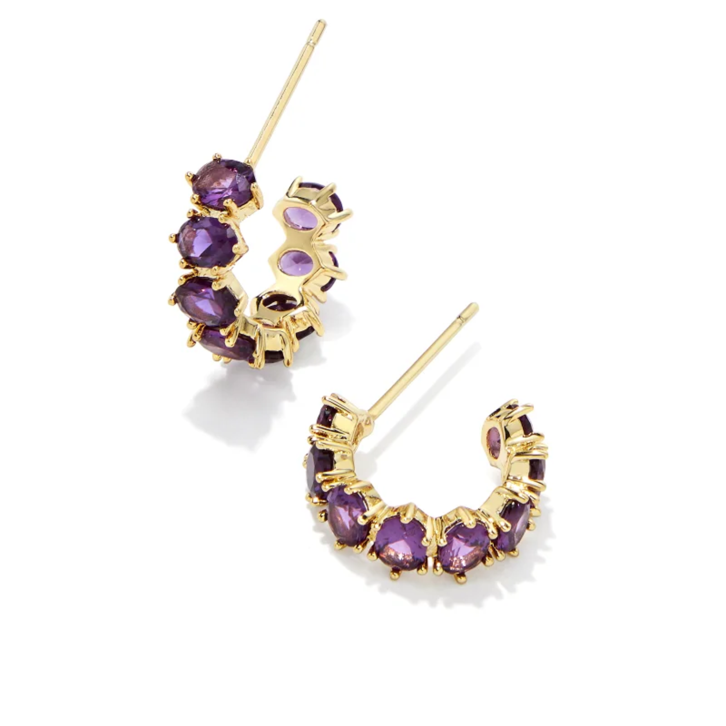 These Cailin Gold Crystal Huggie Earrings in Purple Crystal by Kendra Scott are pictured on a white background.