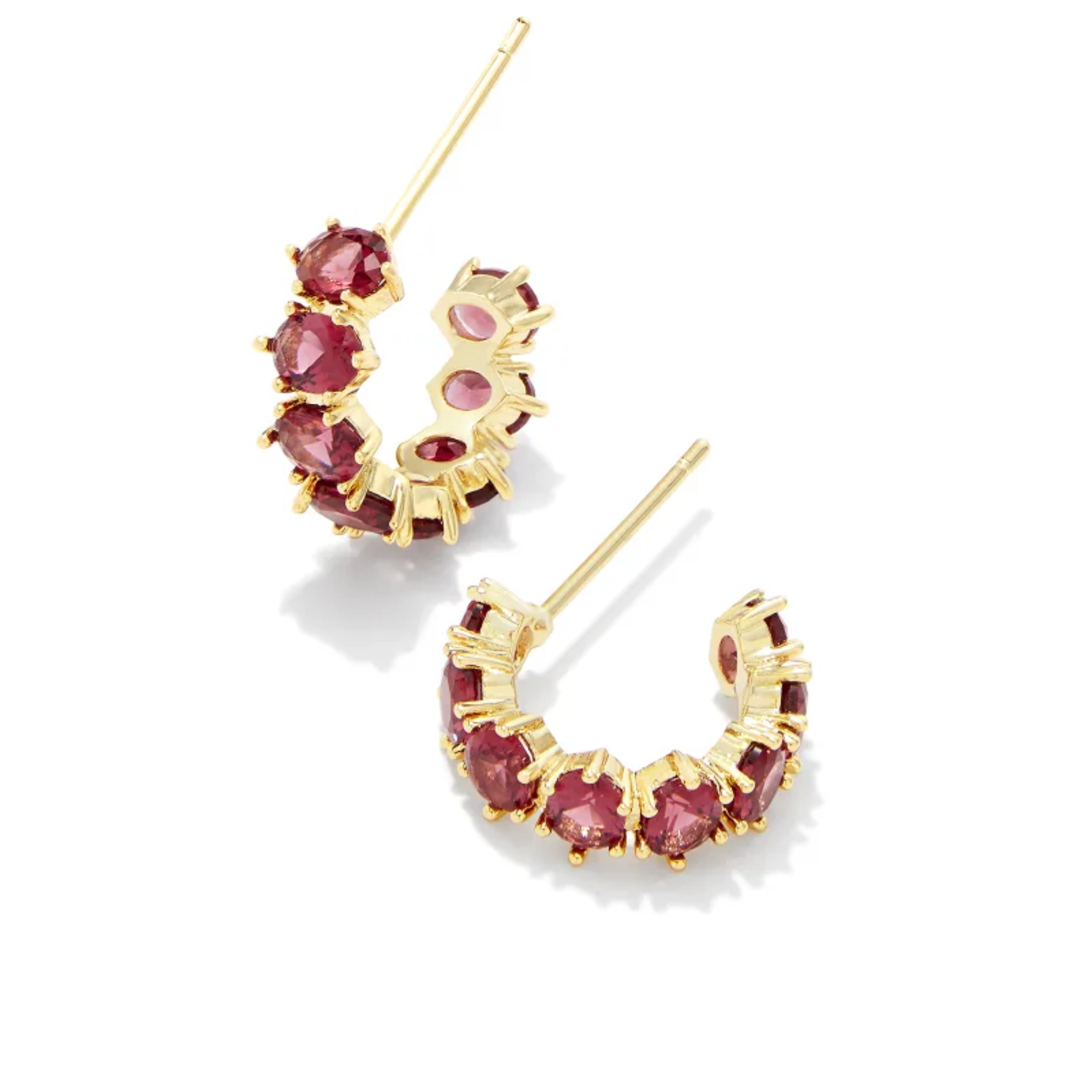These Cailin Gold Crystal Huggie Earrings in Red Crystal by Kendra Scott are pictured on a white background.