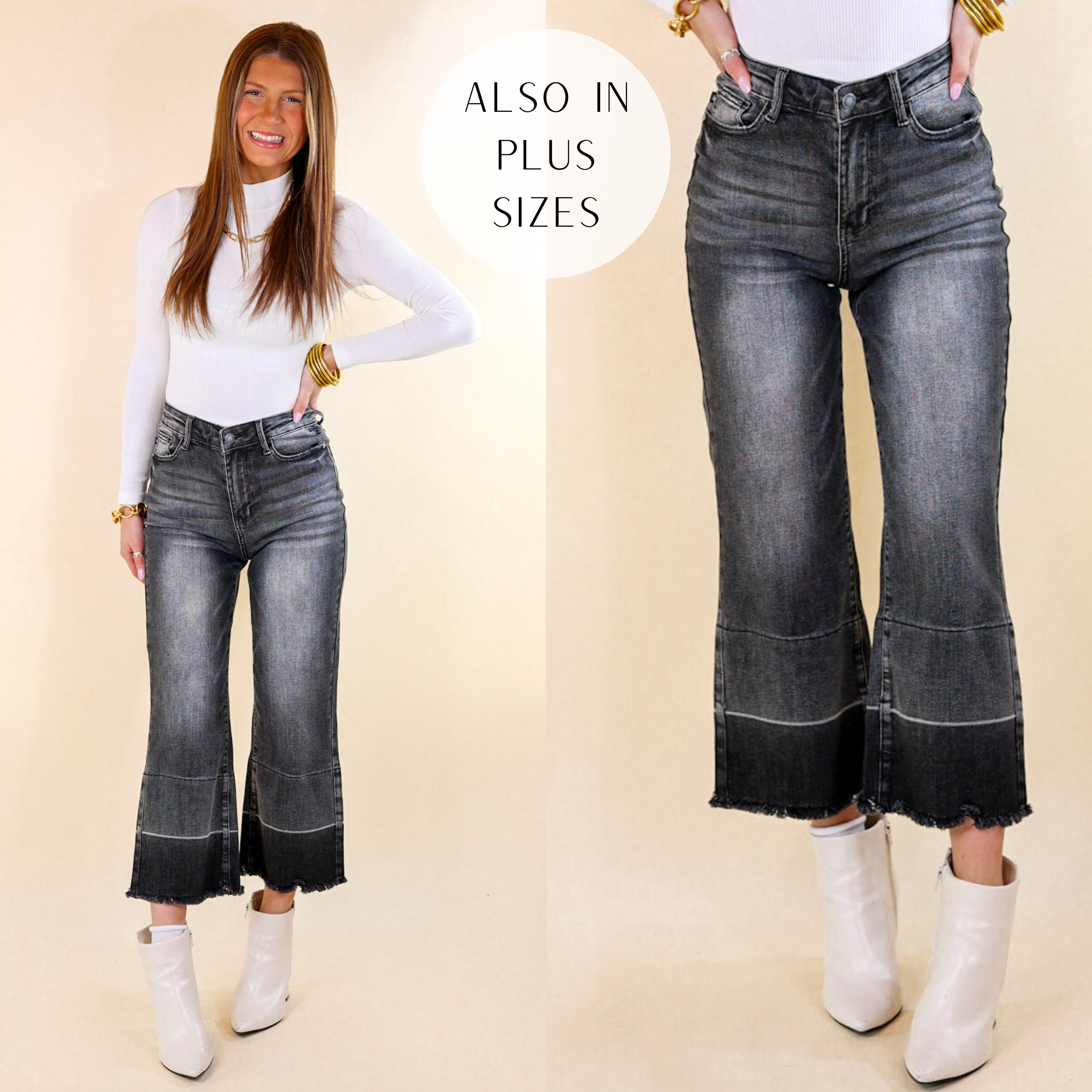 Model is wearing a pair of grey cropped wide leg jeans with a raw hem. Model has it paired with a white top, white booties, and gold jewelry.
