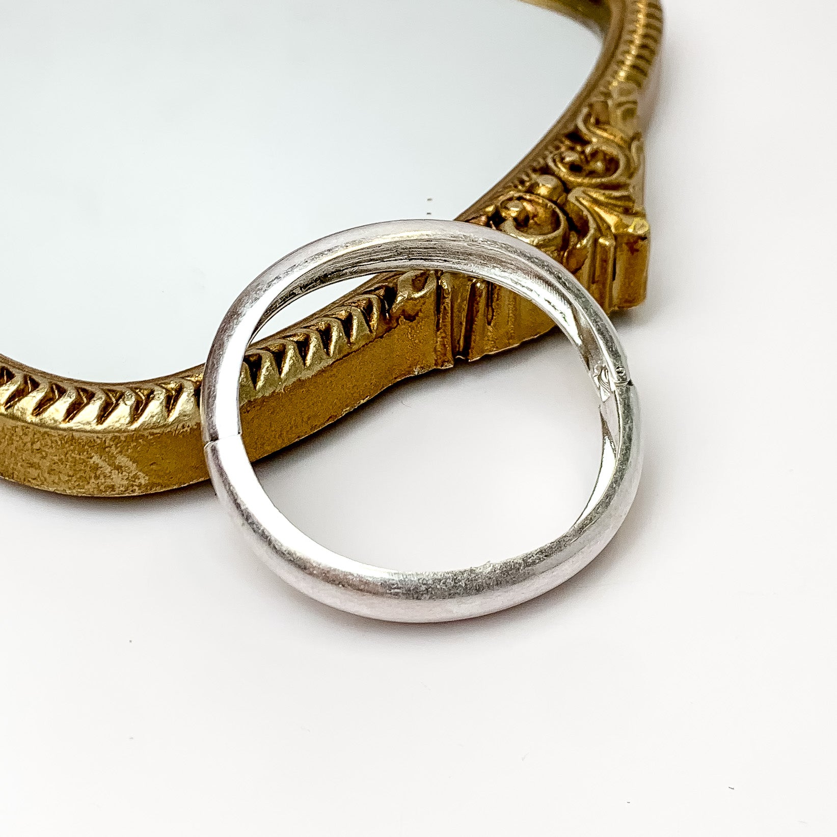 Coastal Chic Silver Tone Magnetic Bracelet. Pictured on a white background with the bracelet leaning against a gold frame mirror.