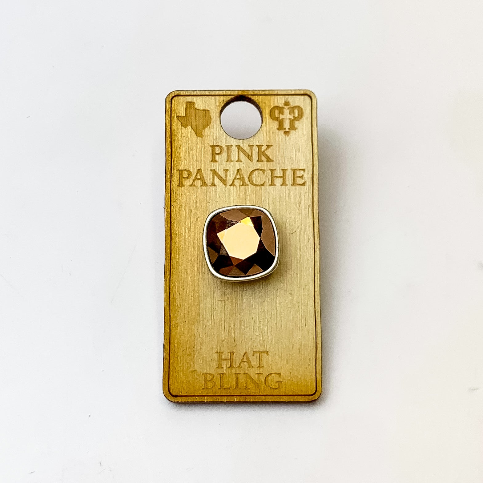Silver, square hat pin with a rose gold cushion cut crystal. This hat pin is pictured on a wooden Pink Panache holder on a white background.