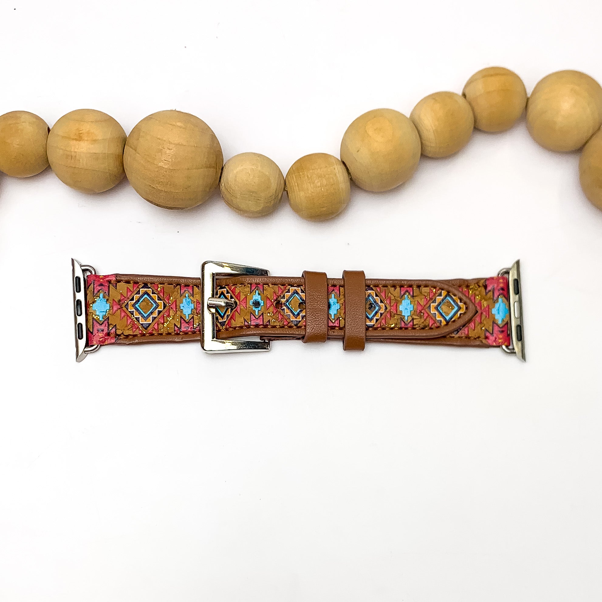 Aztec Printed Brown Apple Watch Band in Multicolor. Pictured on a white background with wood beads above the band for decoration.