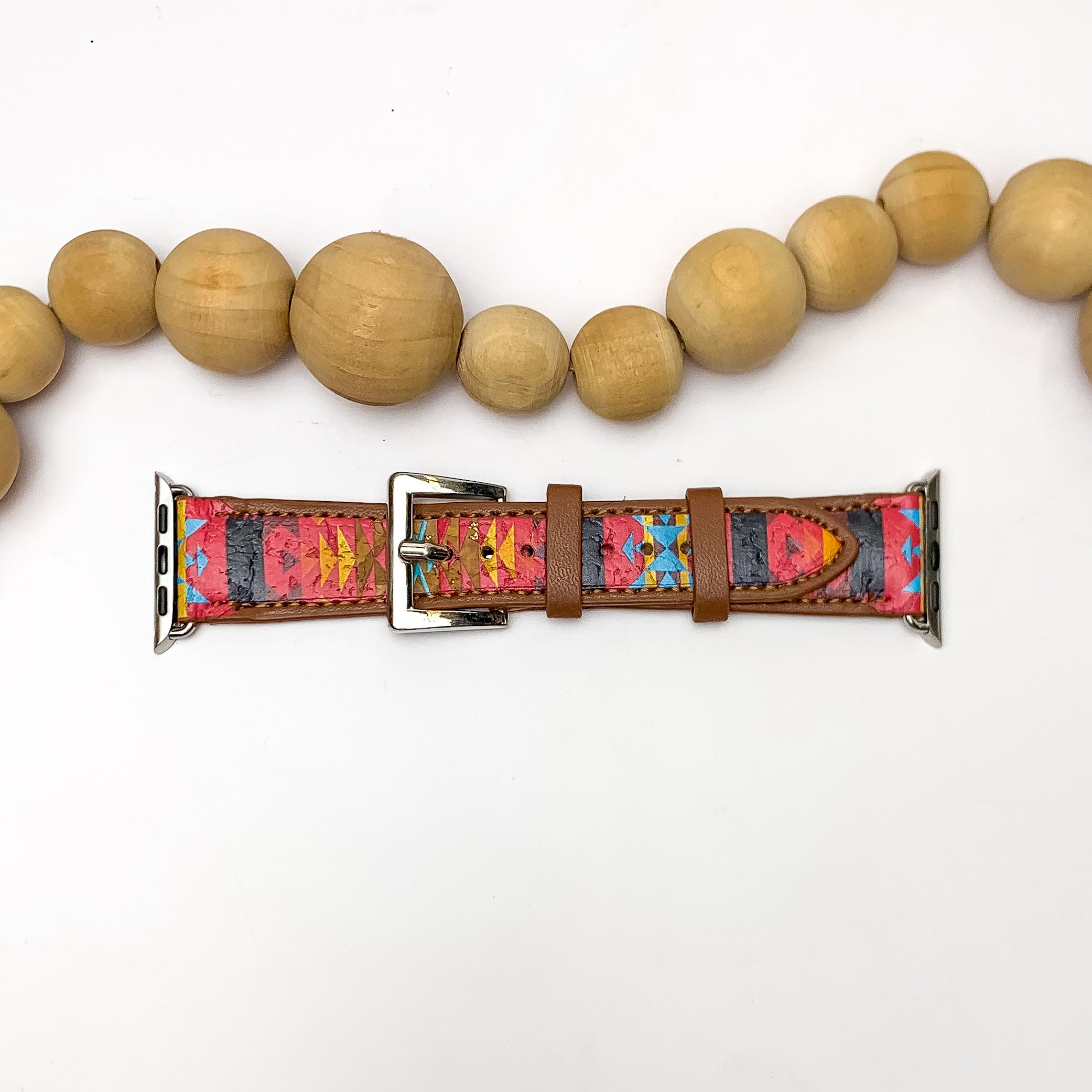 Aztec Printed Brown Apple Watch Band in Red. Pictured on a white background with wood beads above the band for decoration.