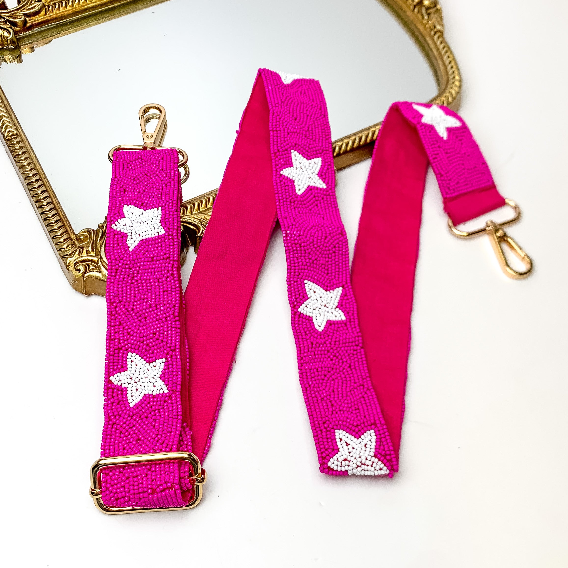 Star of the Show Beaded Adjustable Purse Strap in Pink and White. This purse strap is pictured on a white background with a gold trimmed mirror in the corner.