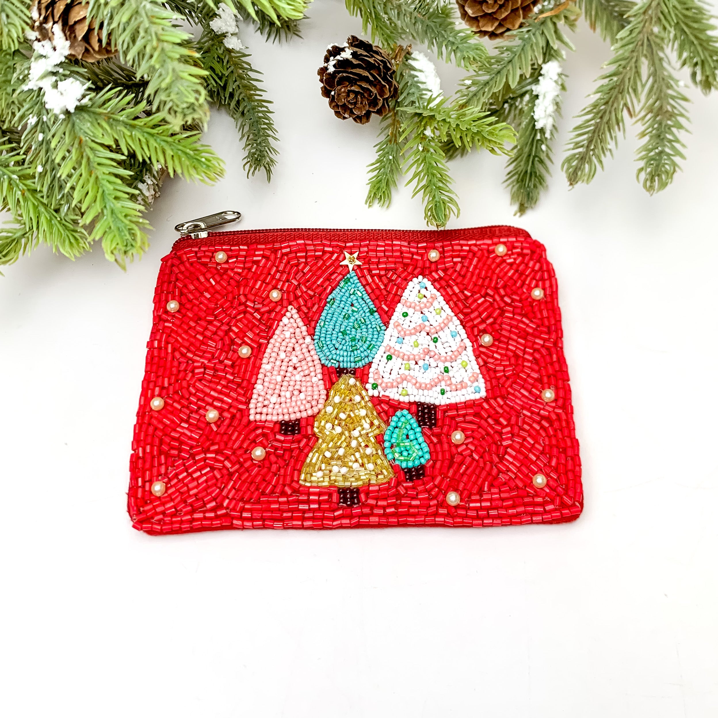 Beaded Coin Purse With Christmas Trees in Red. This coin purse is pictured on a white background with disco balls in the top left corner.
