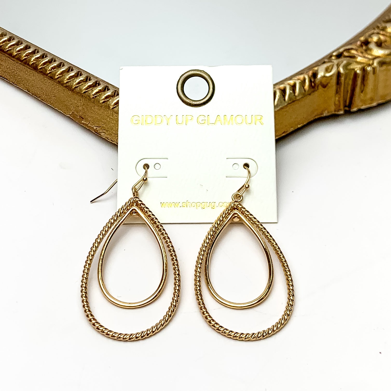 Multiple layered Teardrop Shaped Earrings in Gold Tone. These earrings are pictured on a white background with a gold frame around.