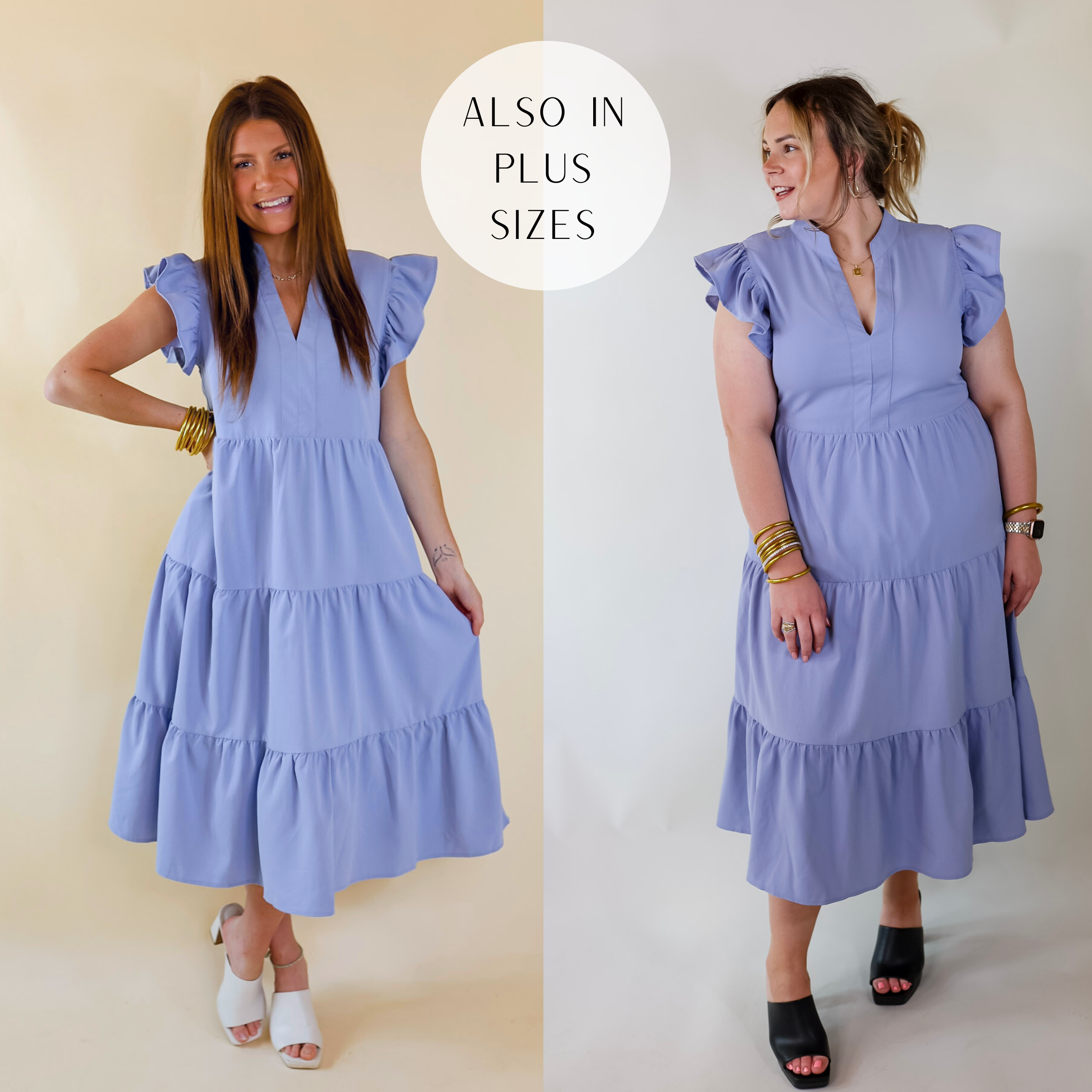 A relaxed fit midi dress in periwinkle. The dress has a V neckline, pockets, tiered skirt, and short flowy ruffled sleeves. Item is pictured on a pale pink background