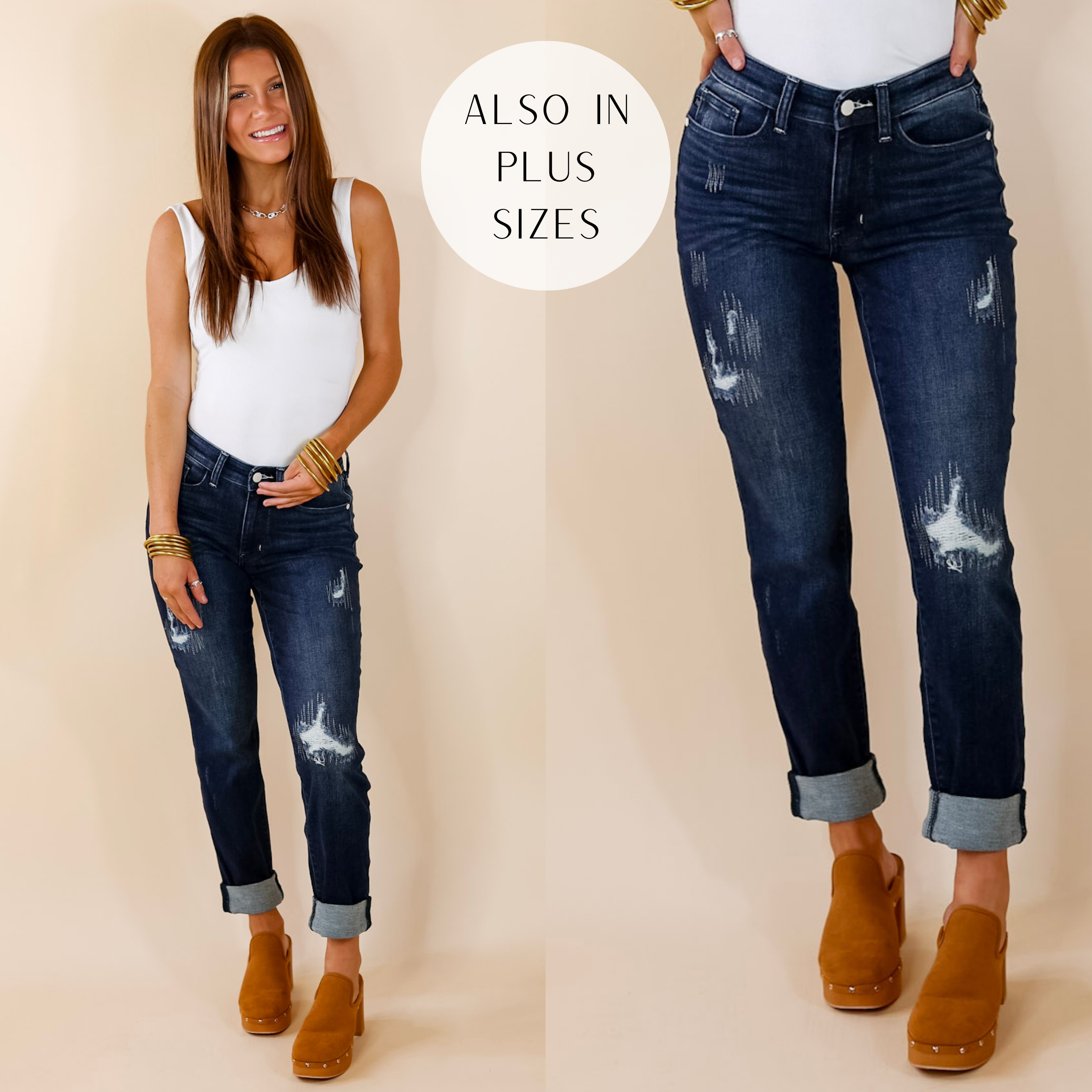 Model is wearing a pair of dark wash cuffed jeans with distressing. Model has these jeans paired with a white bodysuit, tan clogs, and gold jewelry.