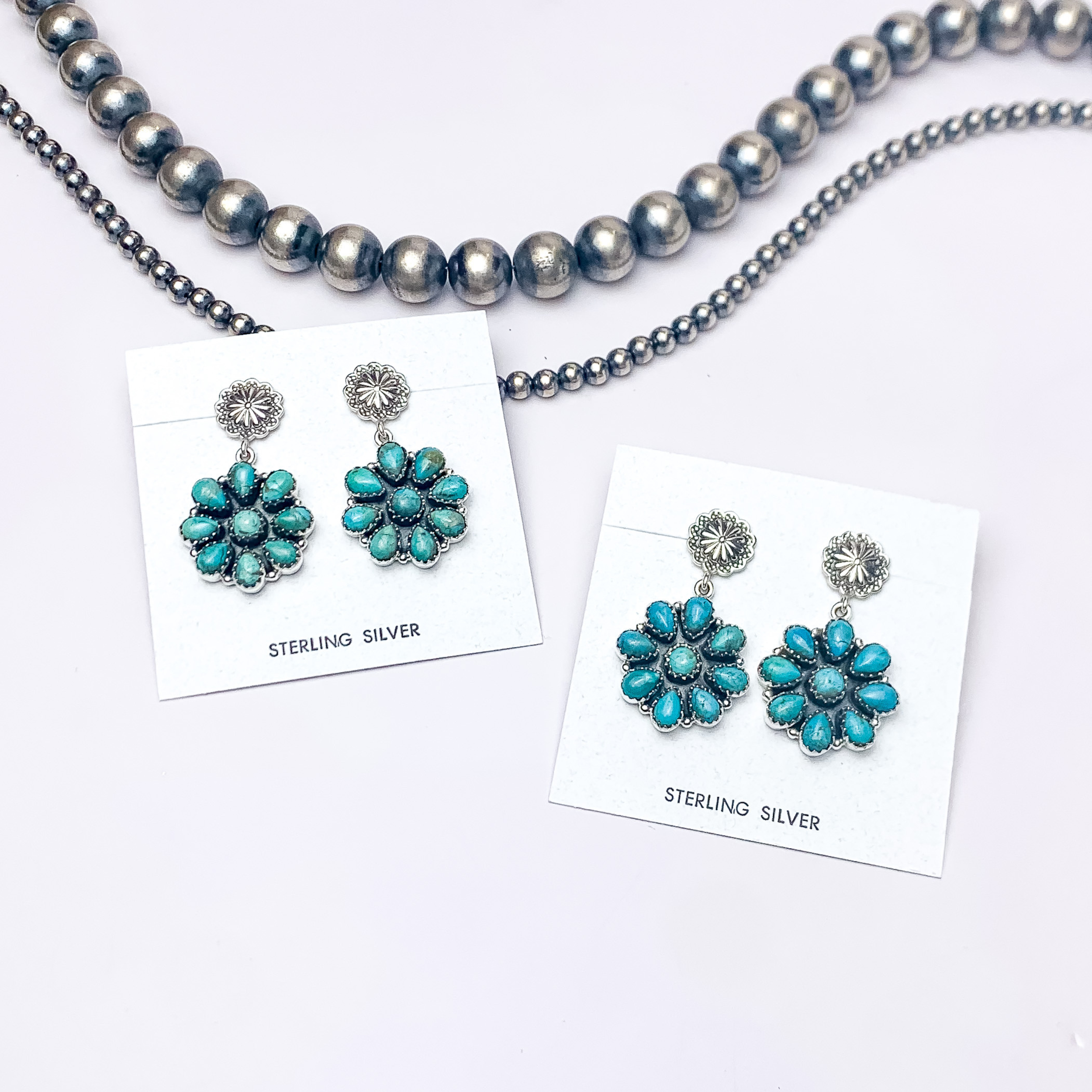 In this picture are stud flower drop kingman turquoise earrings with a white background