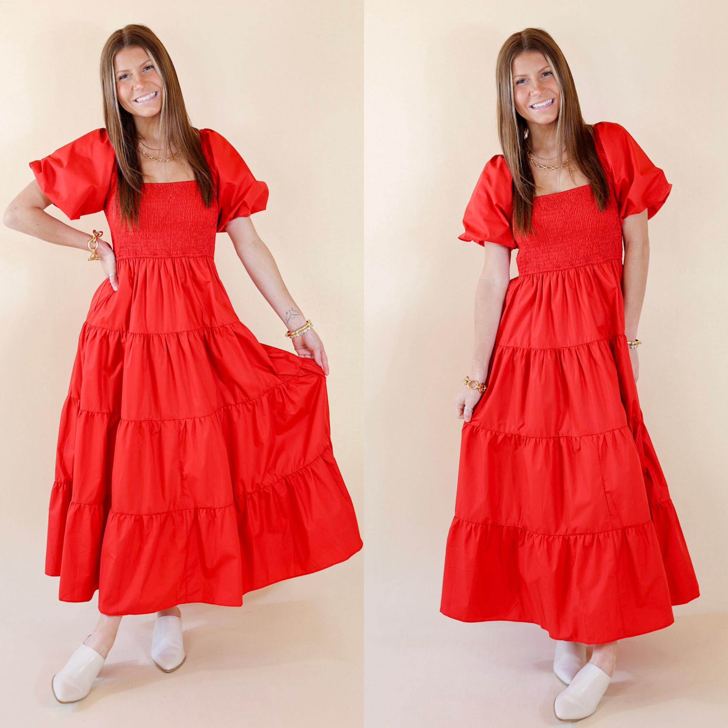 Model is wearing a red maxi dress with short balloon sleeves. Model has it paired with white mules and gold jewelry.