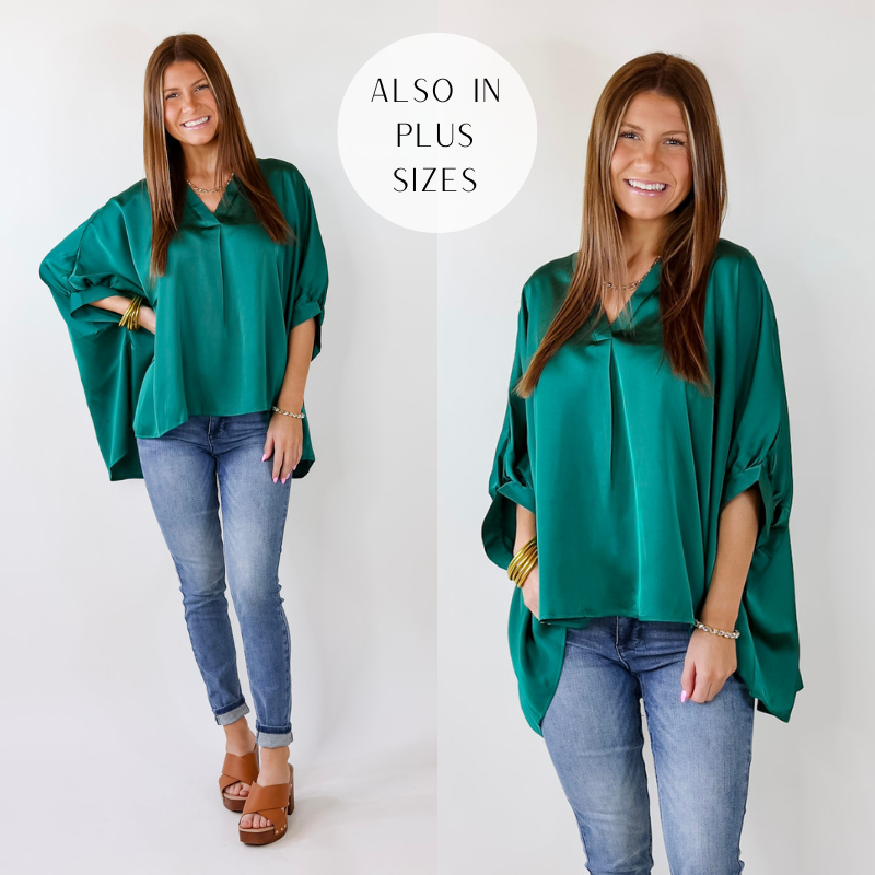 Model is wearing a Green oversized V-Neck Top. The model has paired the top with light skinny jeans, brown sandals, and gold jewelry. 