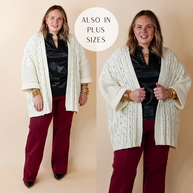 Model is wearing an open front cardigan in ivory. The cardigan has cuffed sleeves and a cable knit material.