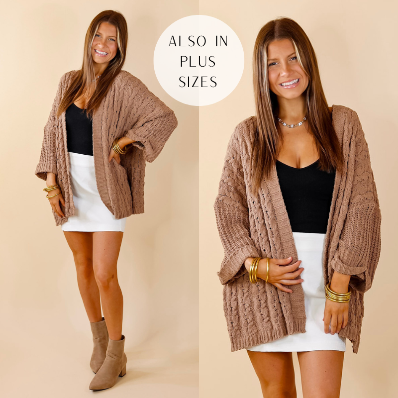 Model is wearing a cappuccino brown cardigan with a cable knit material and open front! Model has paired the cardigan with a black top, white skirt, suede brown boots, and gold tone jewelry. 