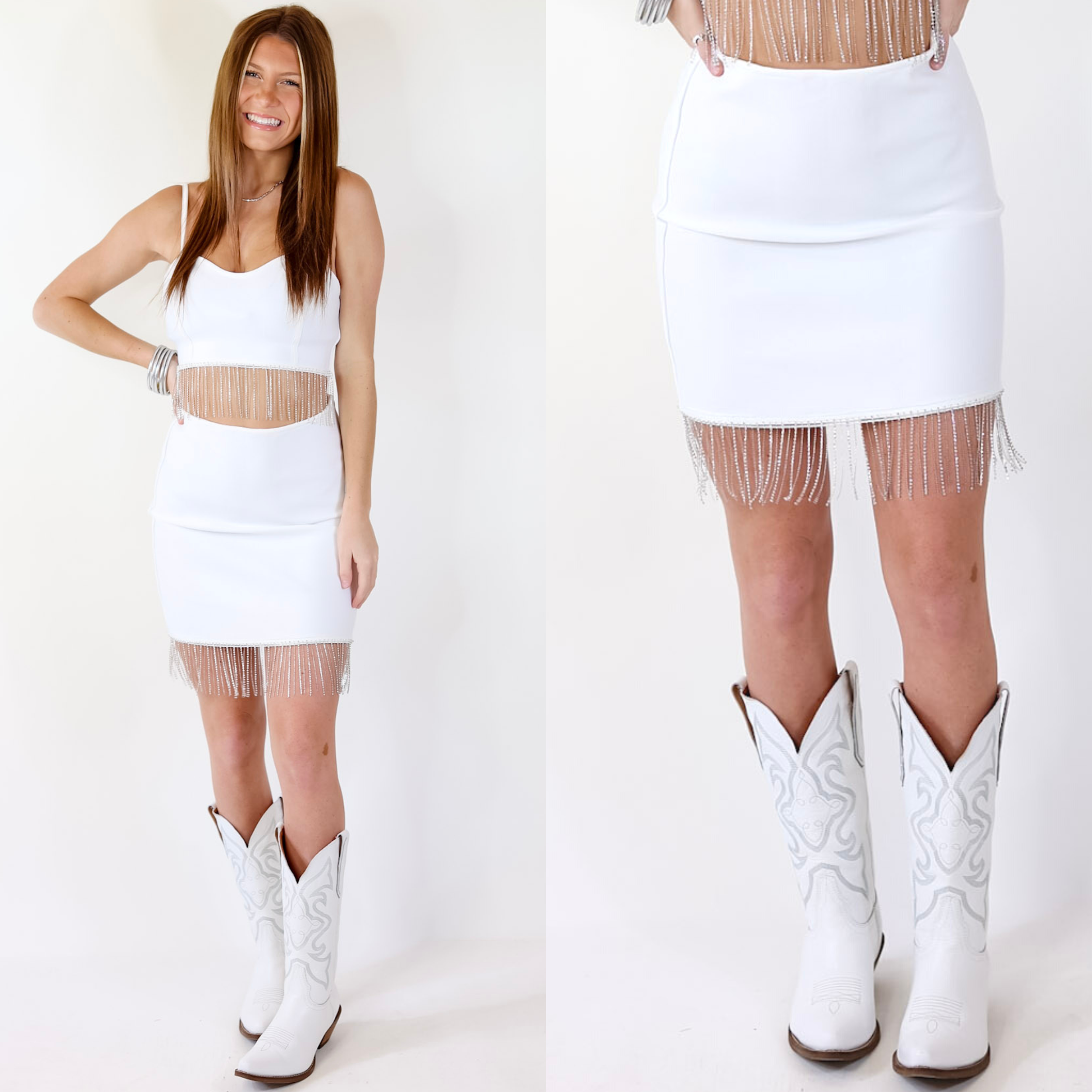 Model is wearing a white  mini skirt with crystal fringe trim. Model has this skirt paired with a matching white top, white boots, and silver jewelry.