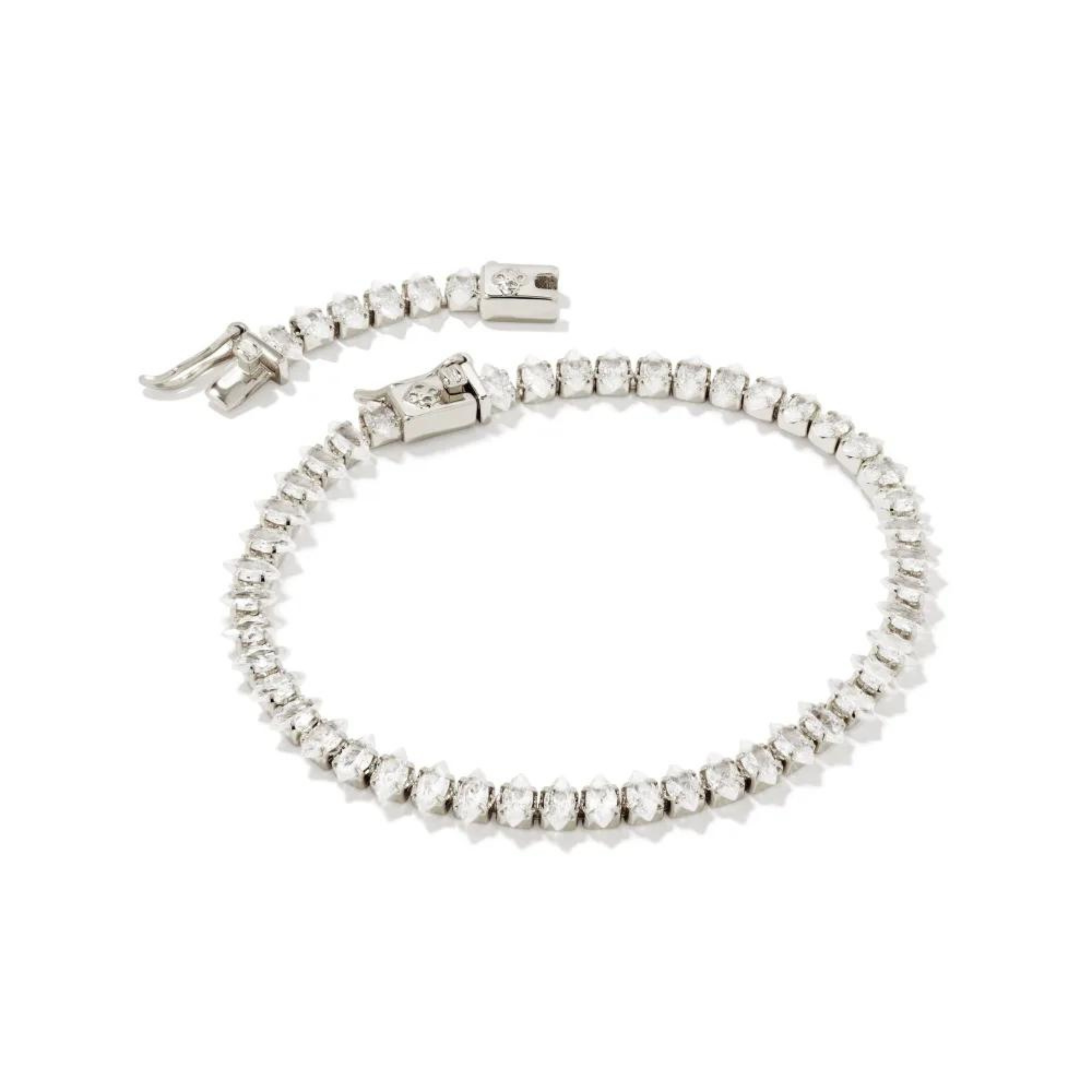Pictured is a clear crystal tennis bracelet in silver on a white background.