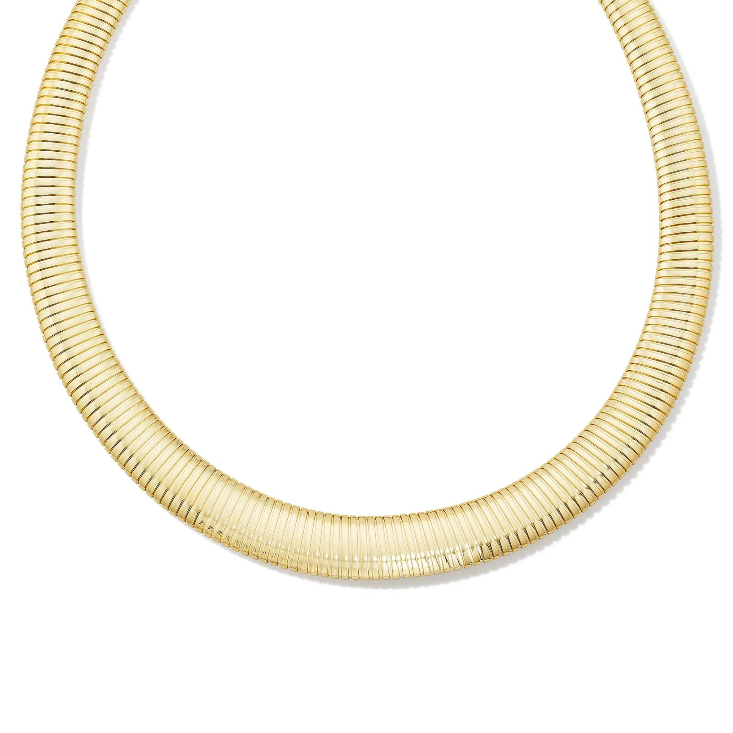 Pictured is a a gold, tubogas necklace on a white background. 
