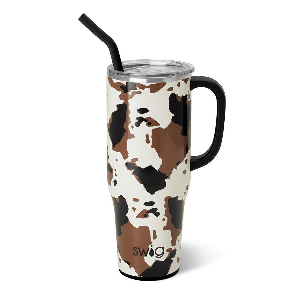 Hayride 40 oz cup. This cup is large with a handle and straw. The cup is cow print with a white background.