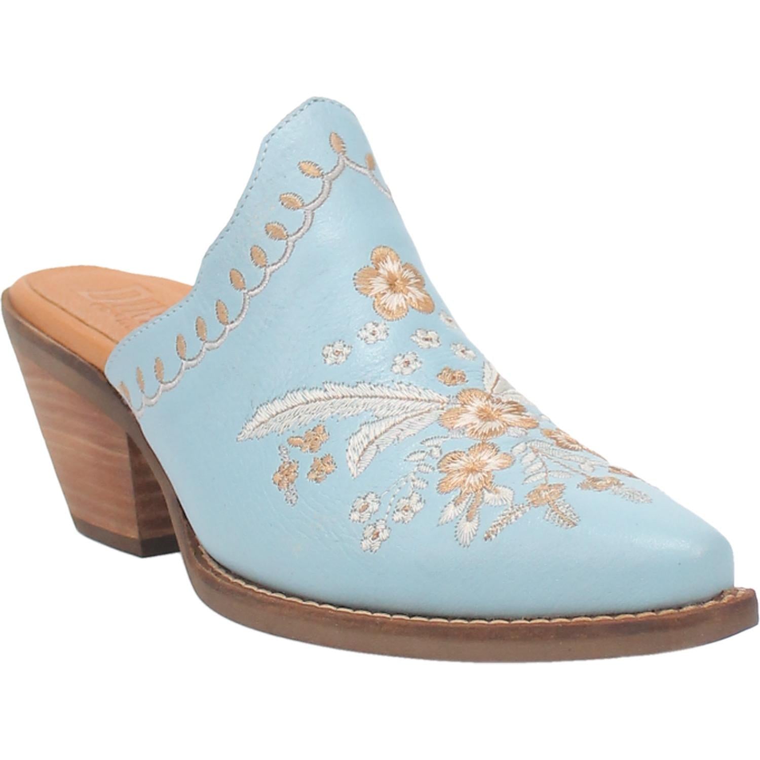 A blue bootie with a white and cream floral and feather design on the upper, a white and cream stitched design on the edge, and a short heel