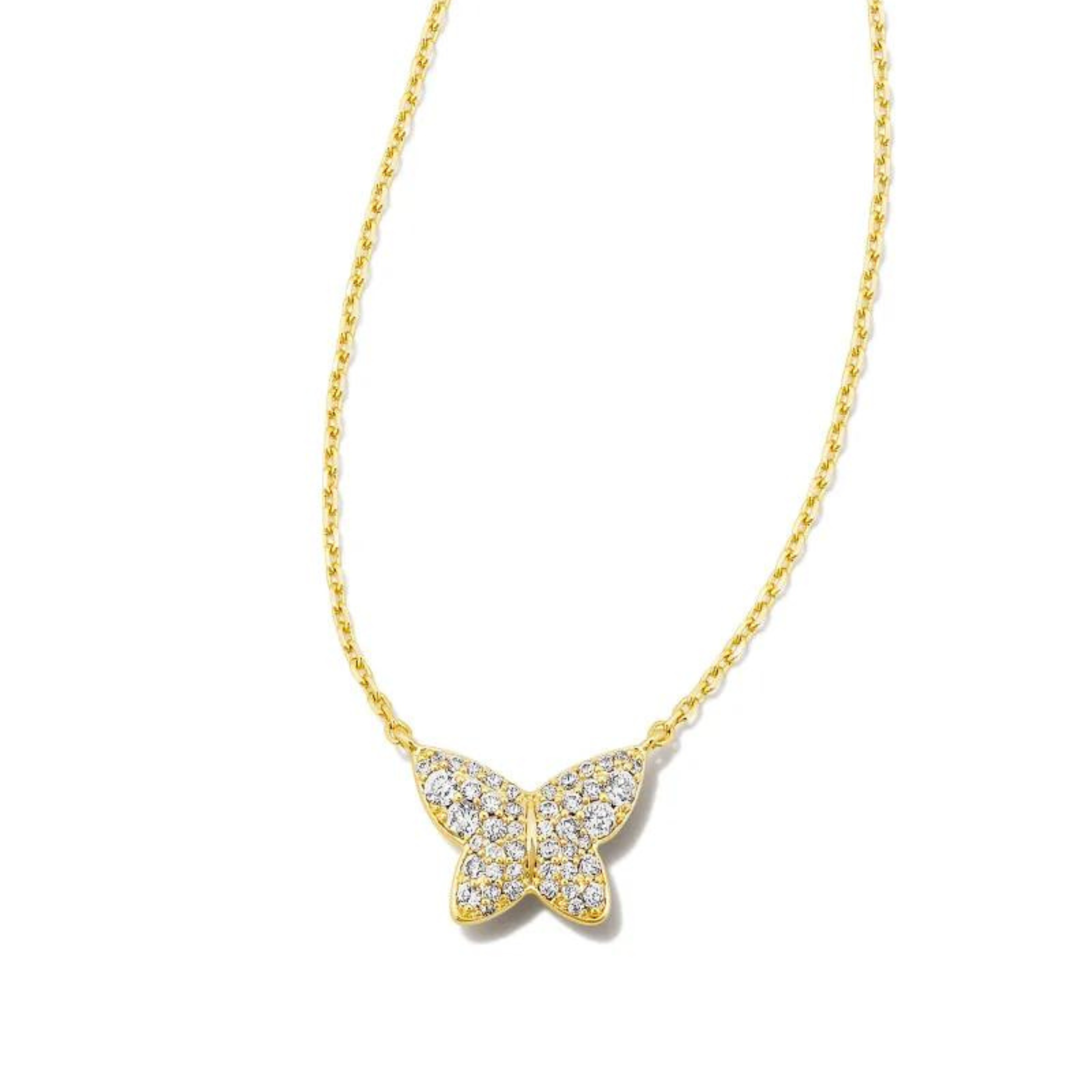Gold necklace with a butterfly pendant with white crystals, pictured on a white background.