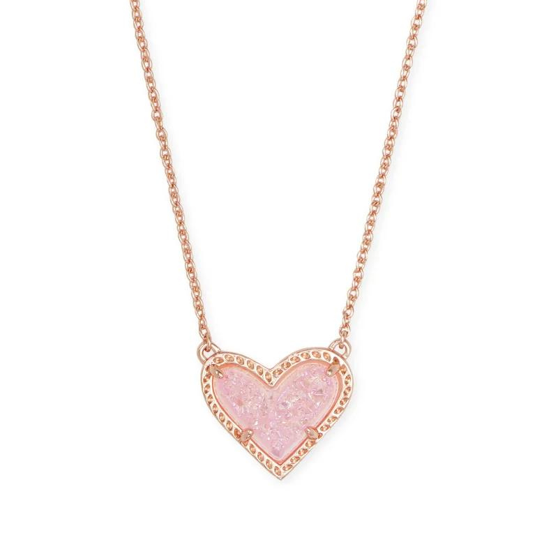 Rose gold heart necklace with pink drusy stone, pictured on a white background.