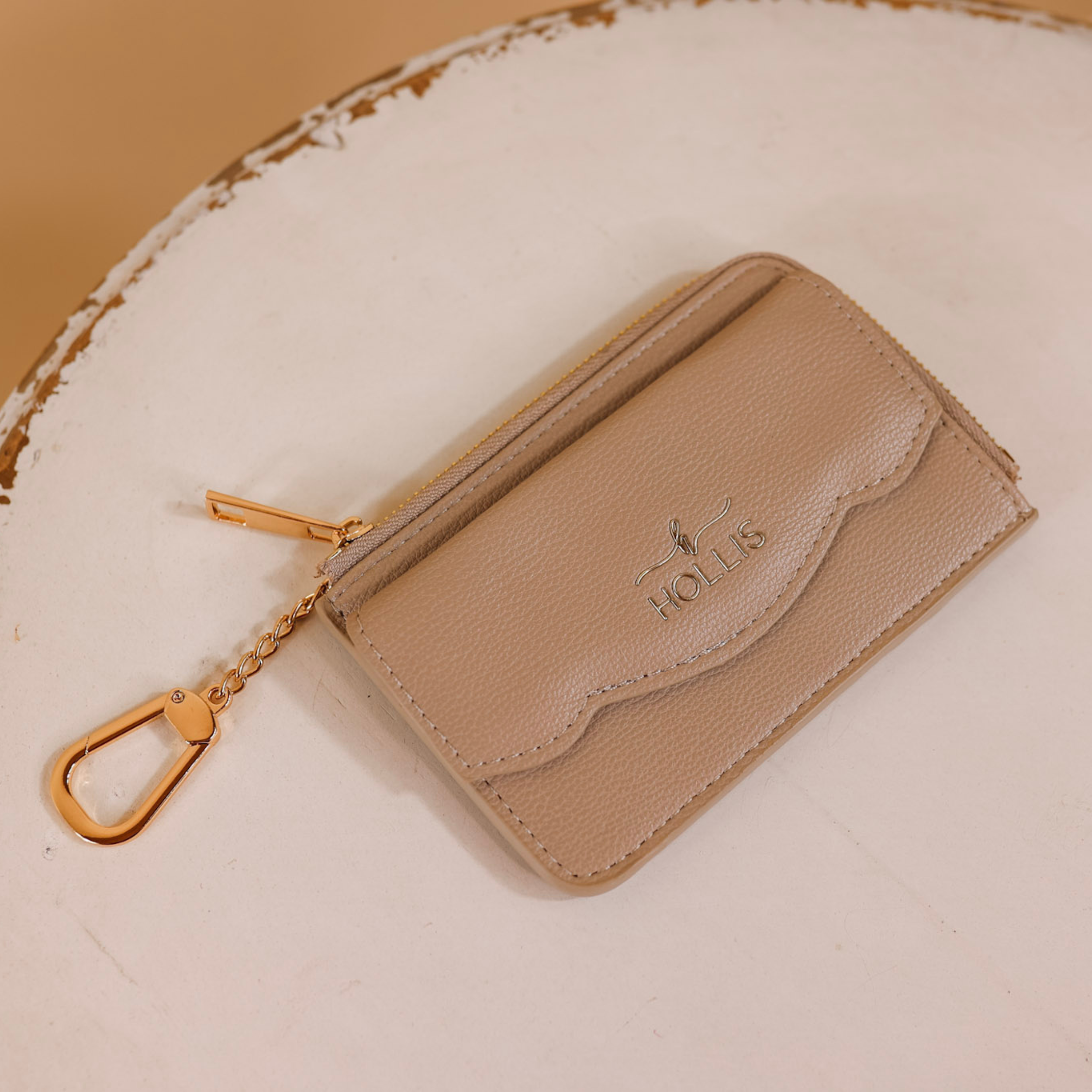 A nude card holder is laid in the center of the picture. Background is solid white.