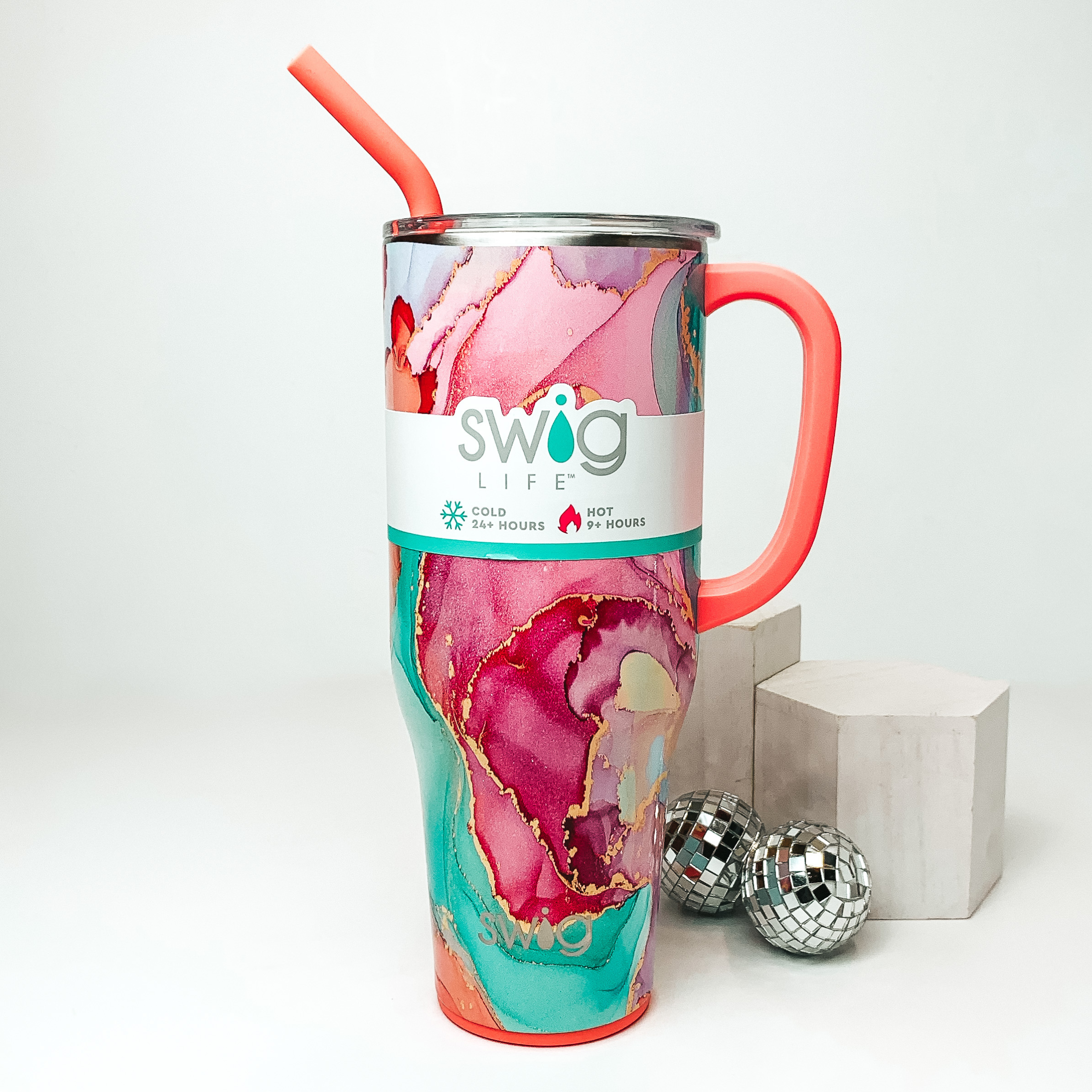 A tall 40 oz mug with a salmon straw and handle, clear lid, and a multi-color pattern containing light blue, pink, purple, white, and orange with a gold outline between each color. Item is pictured on a plain white background