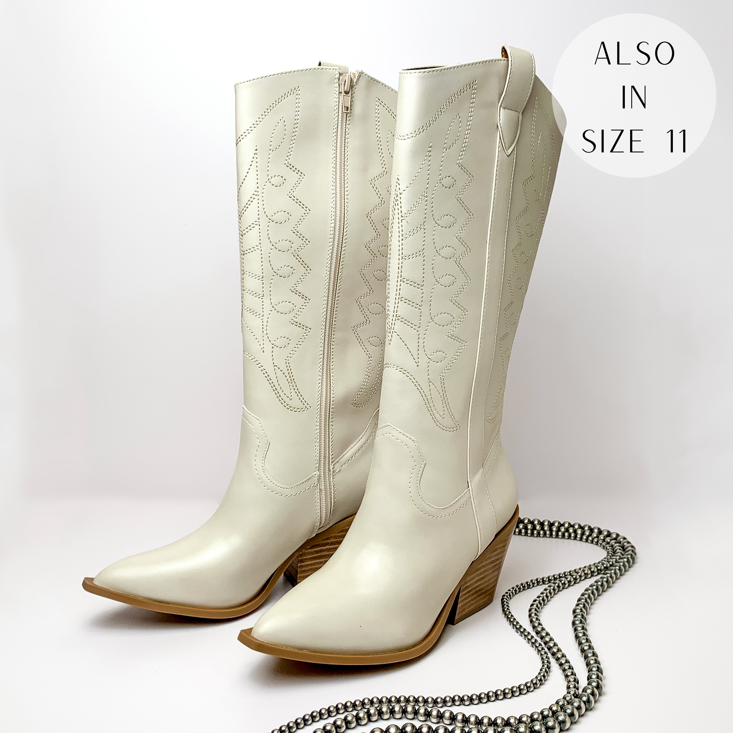 Bone white cowboy boots with ivory western stitching and tan heel. These boots are pictured on a white background with silver beads on the right side of the boots.
