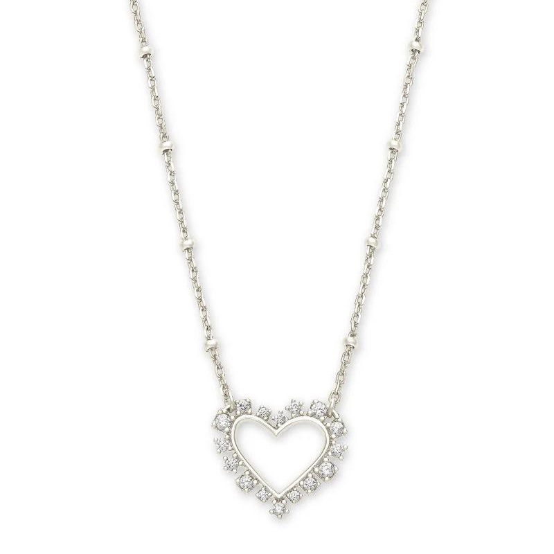 Silver heart necklace surrounded by white crystlas, pictured on a white background.