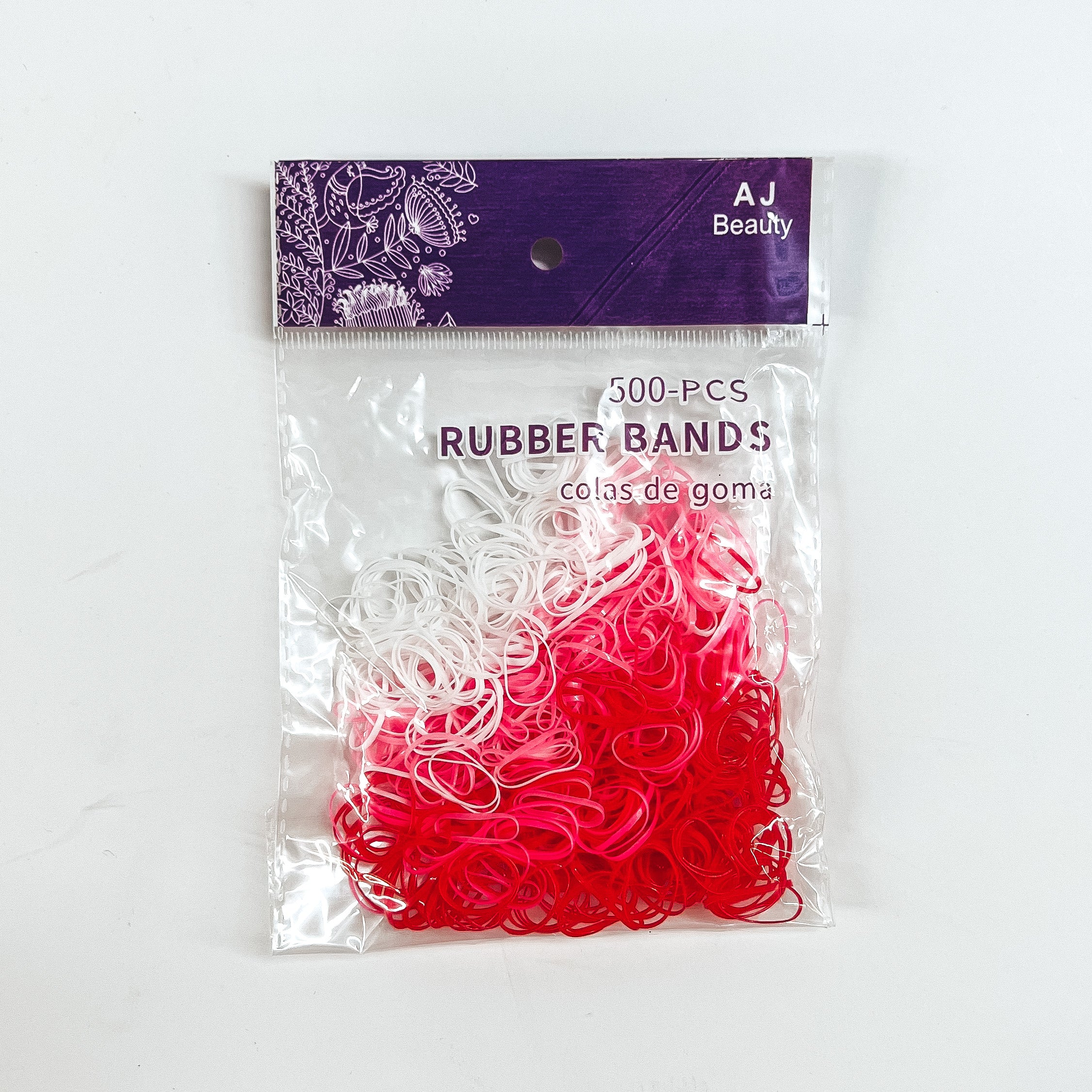 This is a pack of 500 small rubber bands in different colors such as white,  red, and light pink.  This clear and purple pack is taken on a white background.