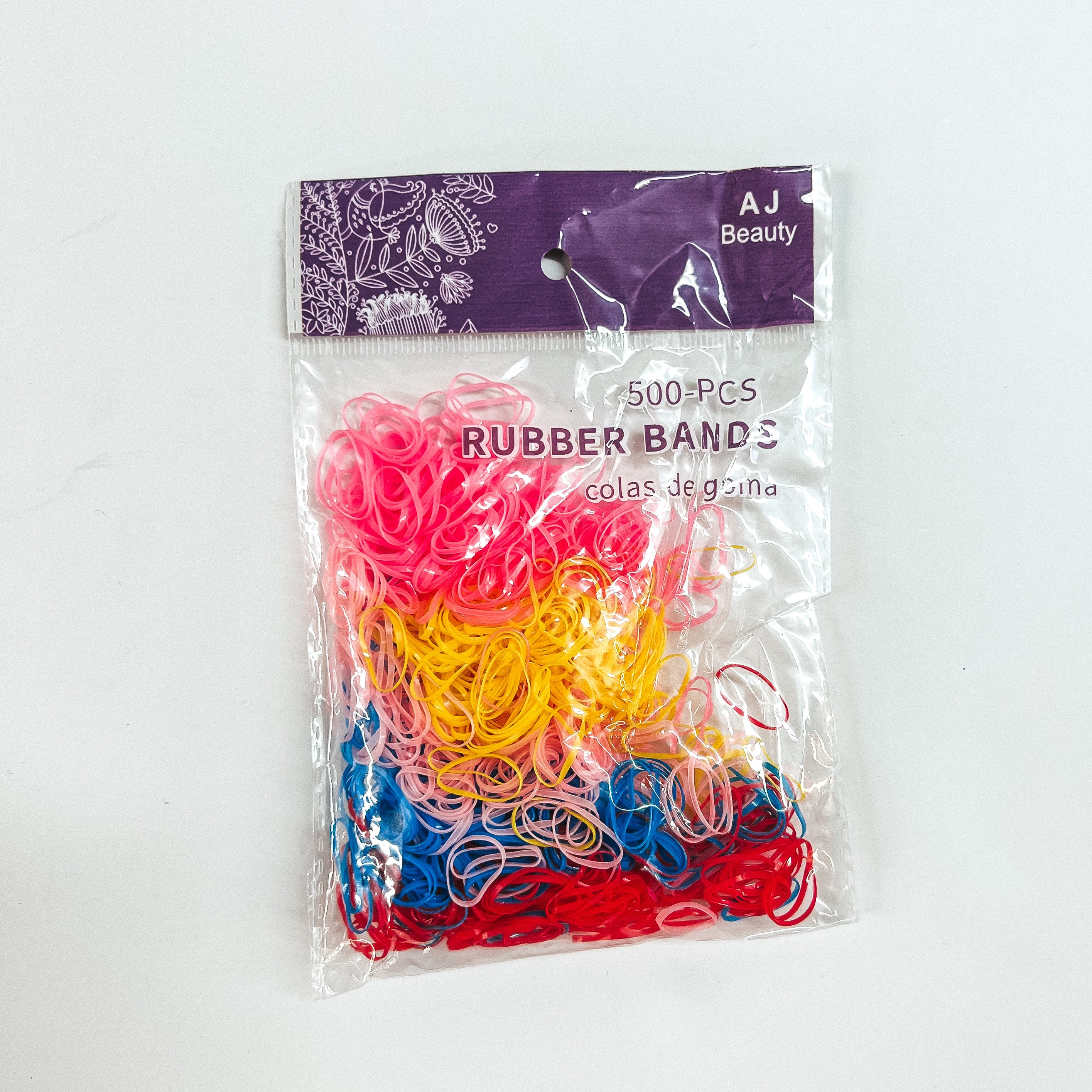 This is a pack of 500 small rubber bands in different colors such as yellow,  pink, blue, red, and light pink.  This clear and purple pack is taken on a white background.