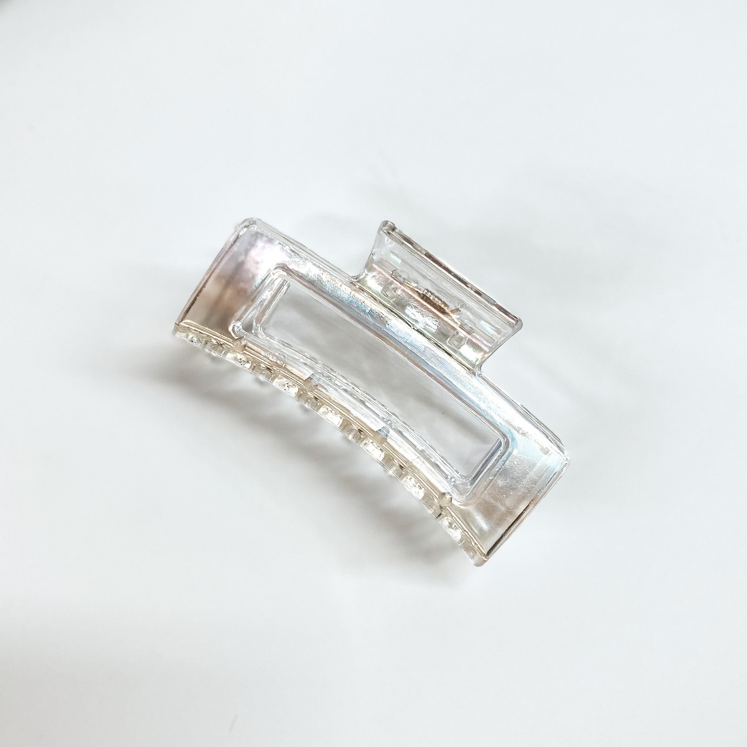Silver, opaque, rectangle hair clip. This hair clip is pictured on a white background.