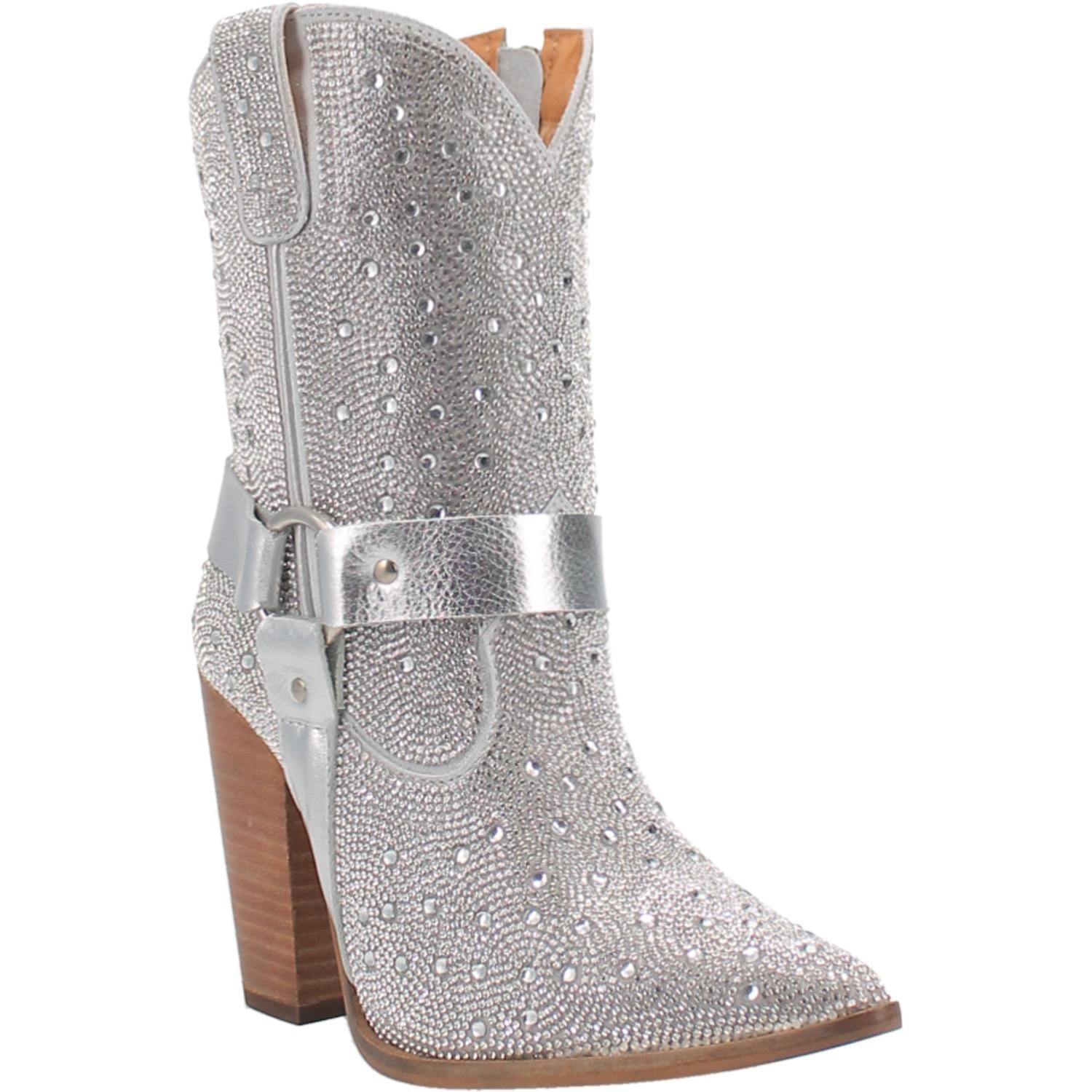 A small silver bootie with rhinestones top to bottom, tall heel, V cut at the top, matching straps, and leather straps going through the middle and under the boot. Item is pictured on a plain white background