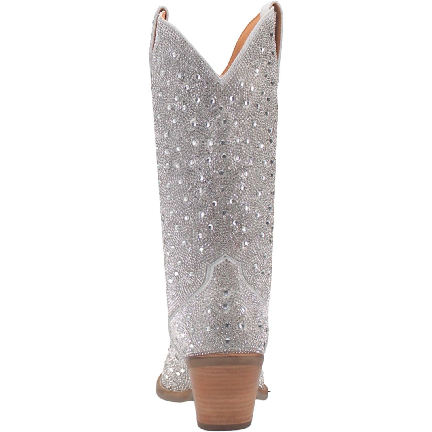 A mid calf length white boot with rhinestones from top to bottom, matching leather straps, a short heel, and a V cut at the top. Item is pictured on a white background