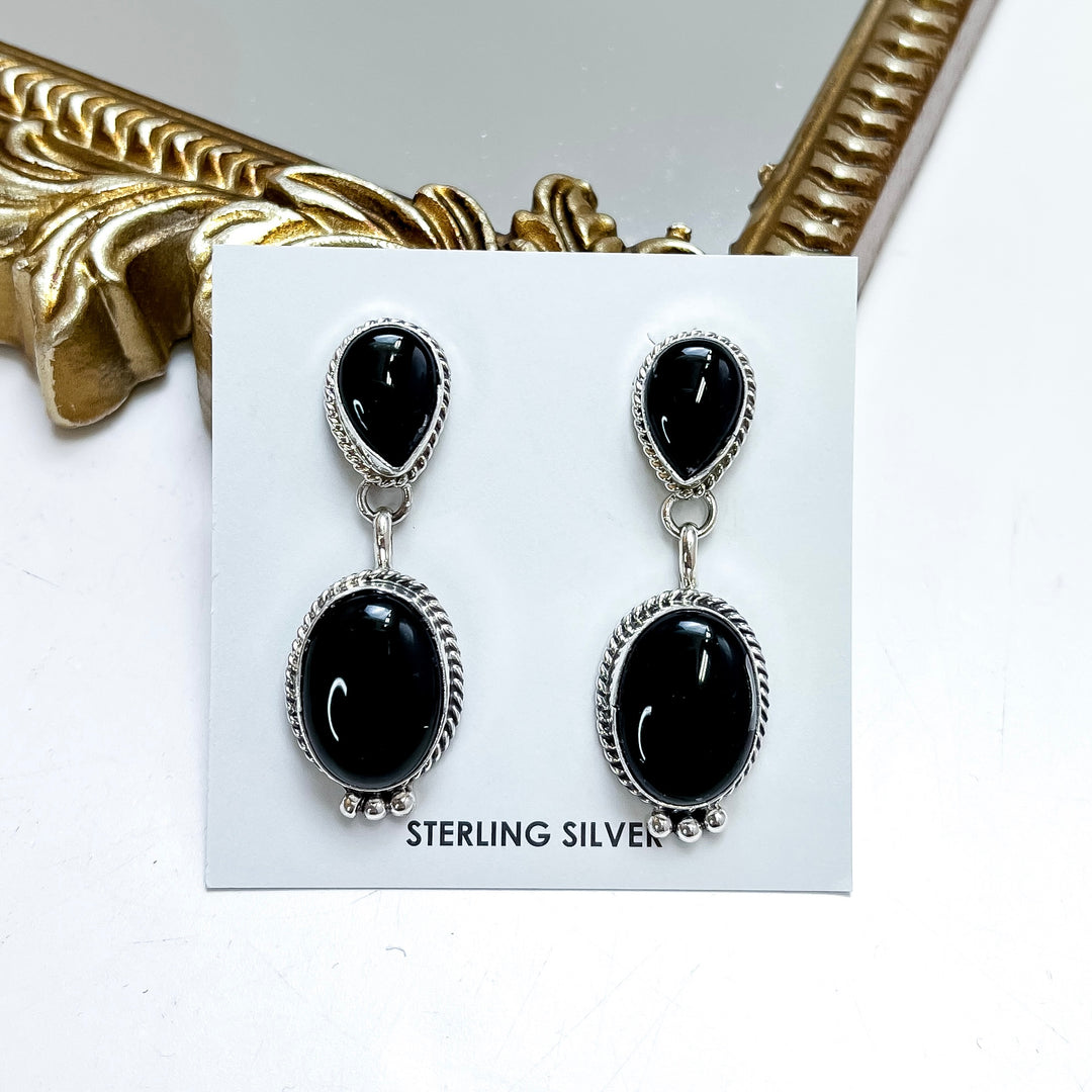 Black onyx and sterling silver drop earrings handmade by Native American artist Freida Martinez featuring elegant double stone southwestern styling.