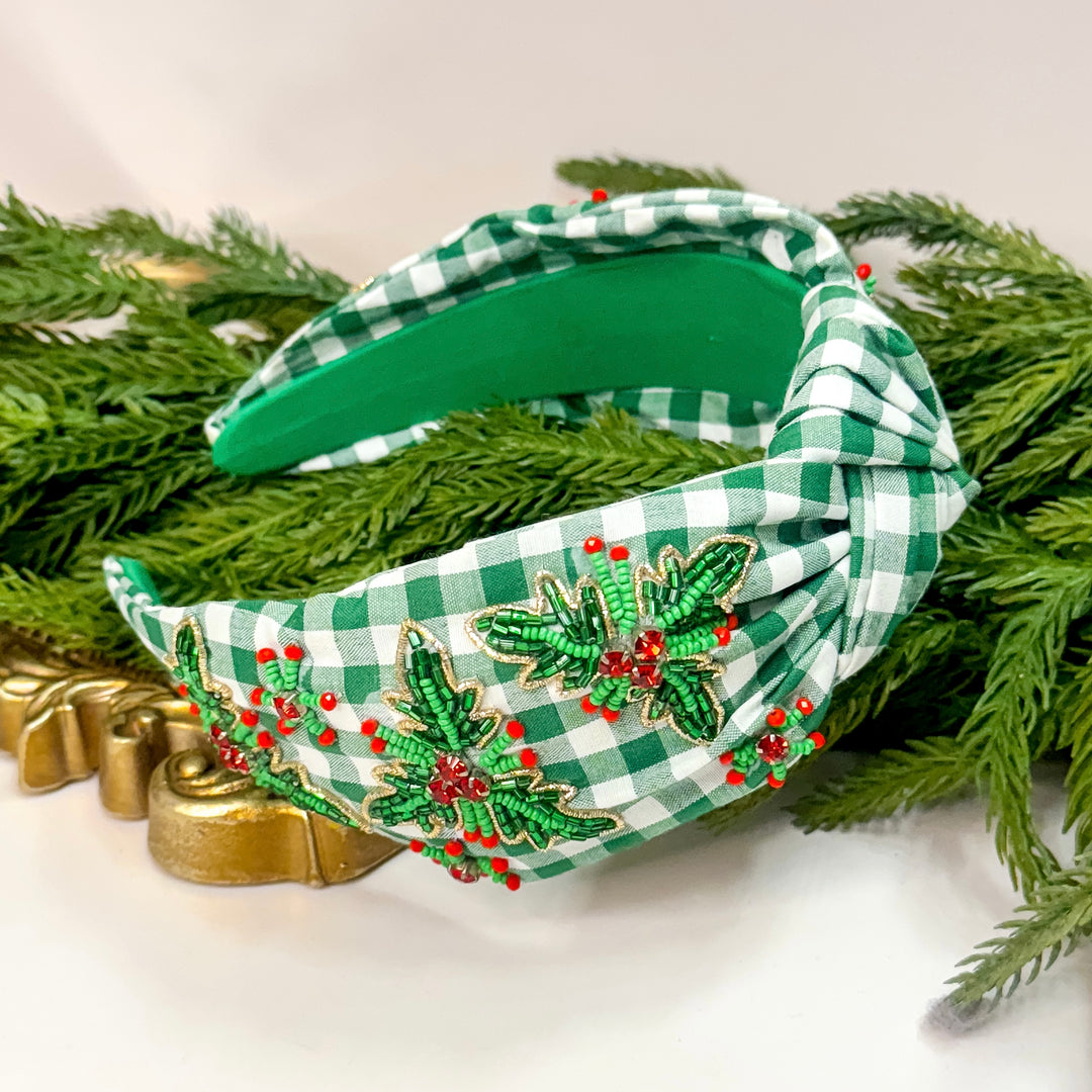 Green and white checkered headband with festive decorations on a green leafy background