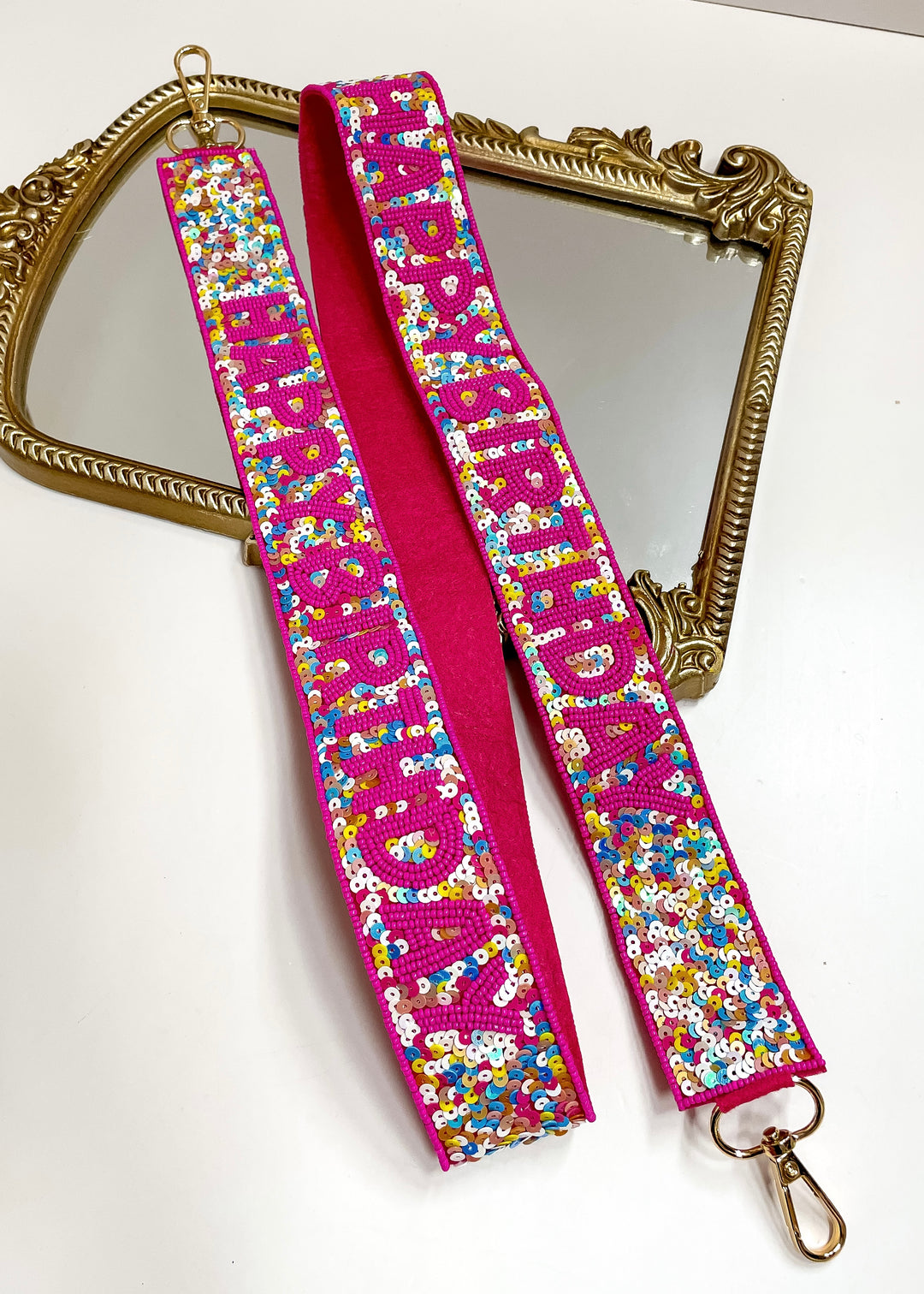 Colorful strap with floral pattern and pink border on a white background