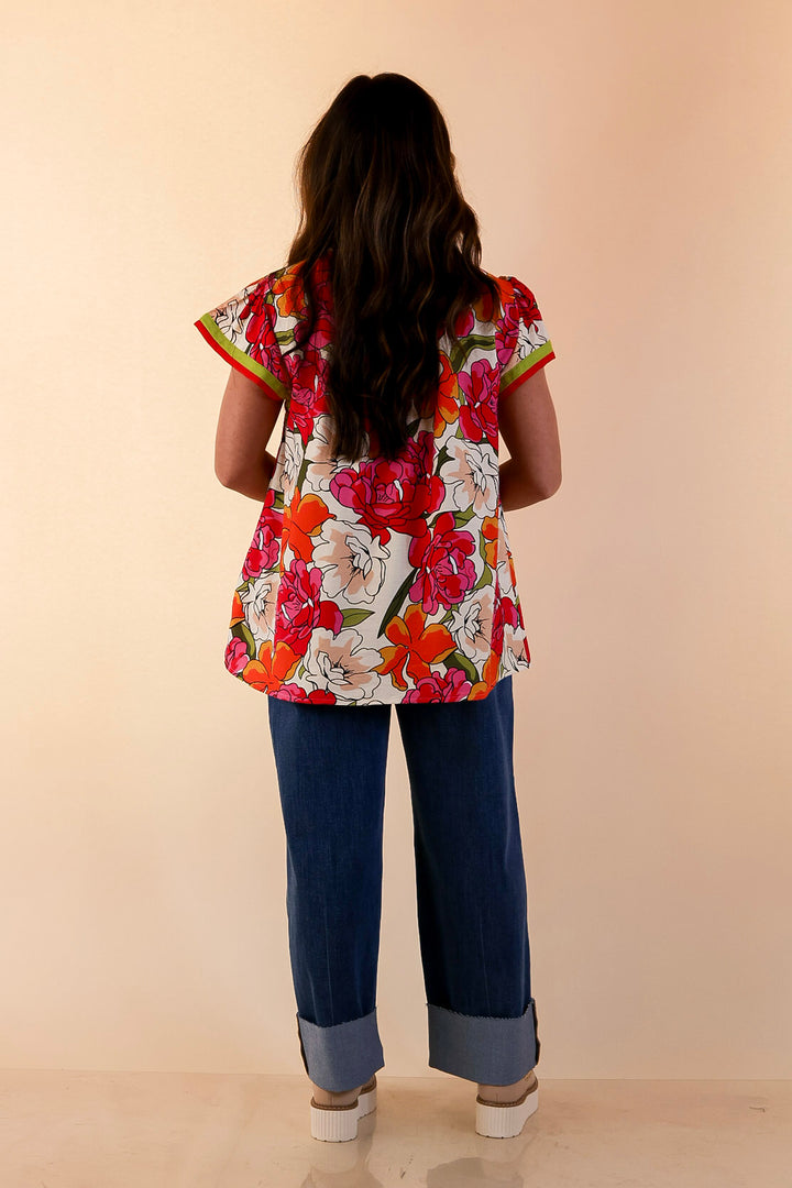 Spring Symphony Floral Print Flutter Sleeve Top with Contrast Trim Split Neckline in Pink and Orange