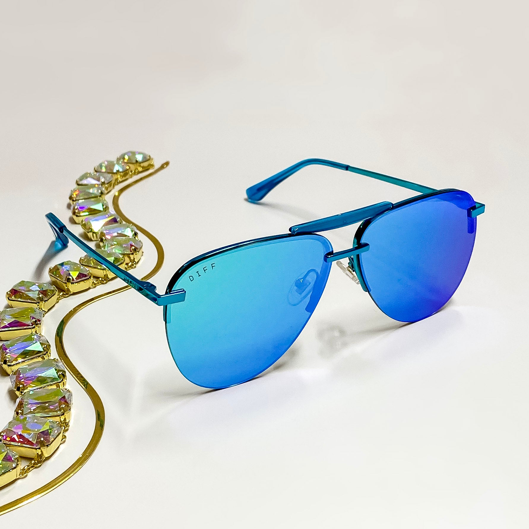 A pair of entirely metallic turquoise aviator style sunglasses