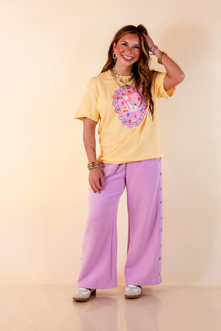 Goose on the Loose Whimsical Pink Background with Stars and Hearts Goose Printed Graphic Tee in Butter Yellow