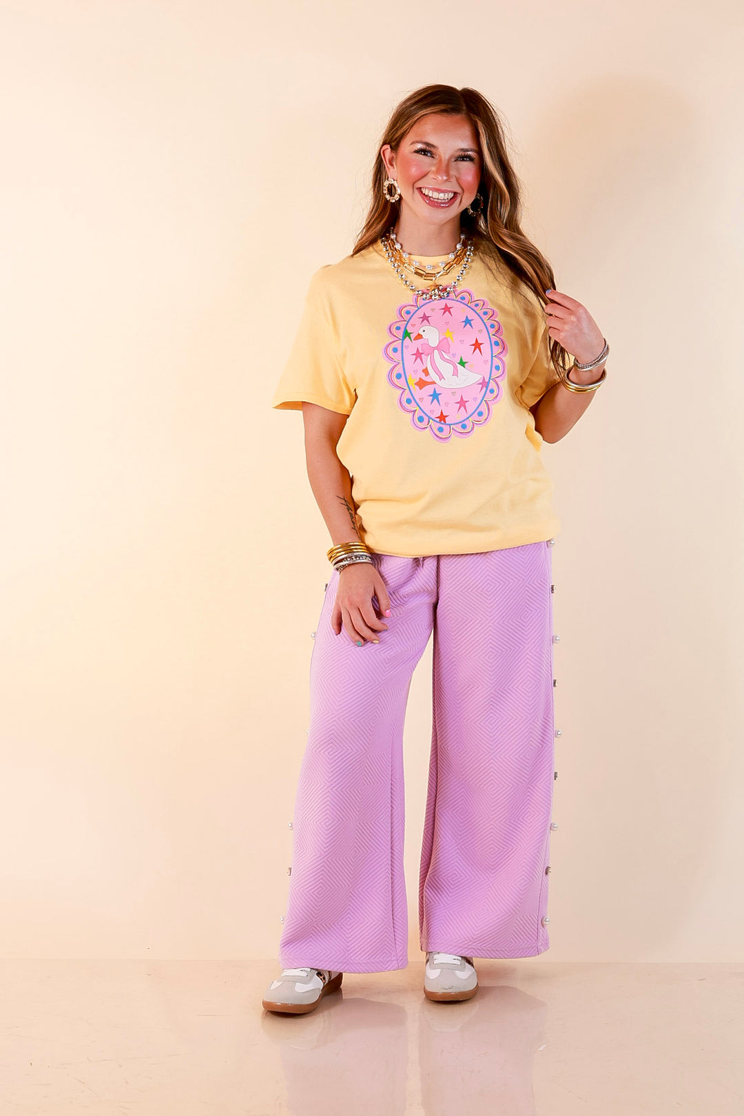 Goose on the Loose Whimsical Pink Background with Stars and Hearts Goose Printed Graphic Tee in Butter Yellow