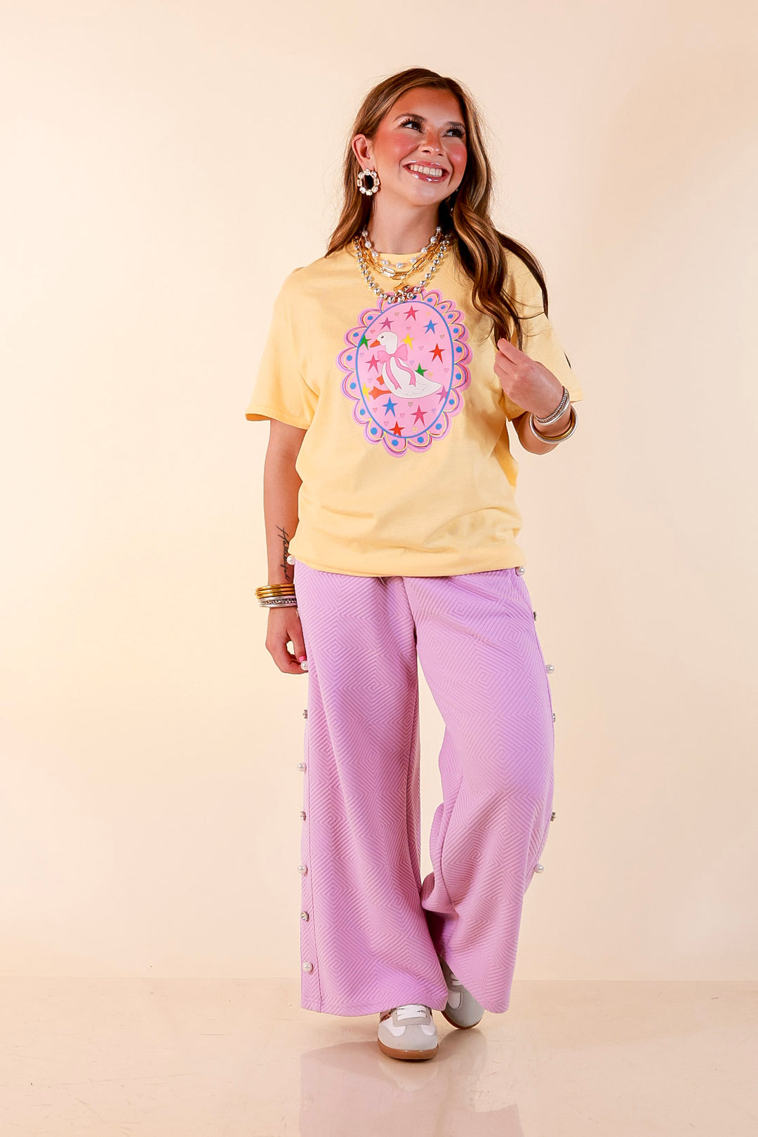 Goose on the Loose Whimsical Pink Background with Stars and Hearts Goose Printed Graphic Tee in Butter Yellow