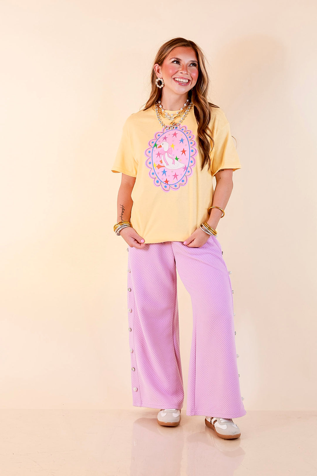 Goose on the Loose Whimsical Pink Background with Stars and Hearts Goose Printed Graphic Tee in Butter Yellow