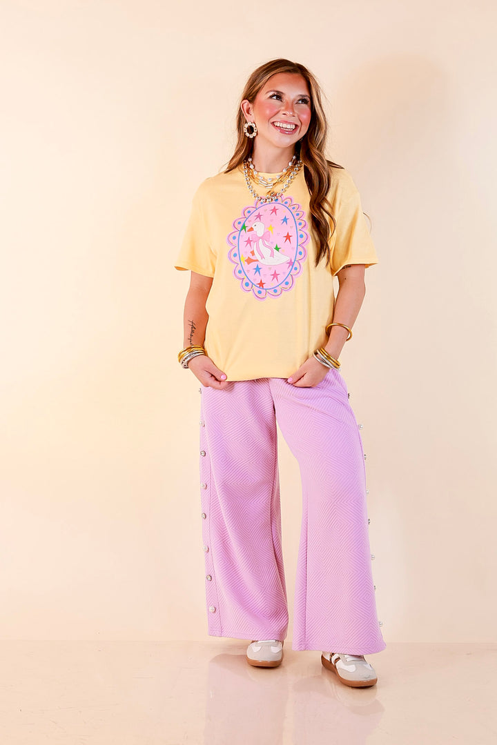 Goose on the Loose Whimsical Pink Background with Stars and Hearts Goose Printed Graphic Tee in Butter Yellow