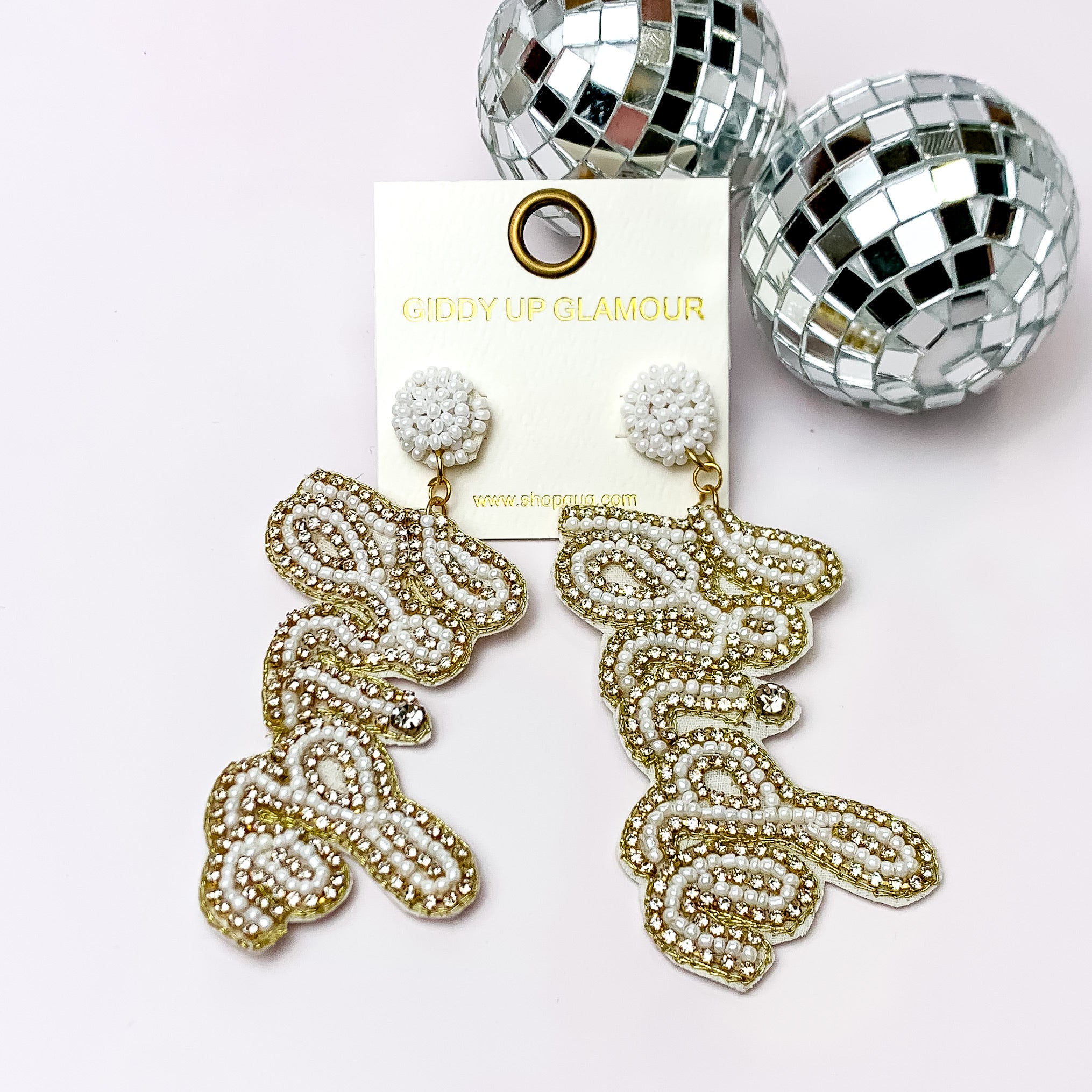 Beaded Bride Earrings with Clear Crystals in Gold, and White. Pictured on a white background with disco balls in the top left.
