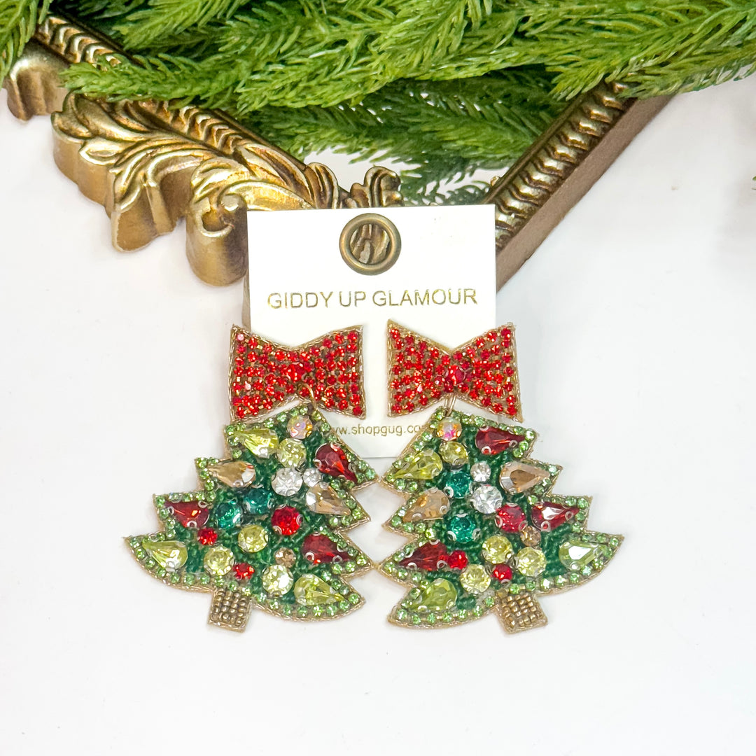 Decorative earrings with gemstones on a 'Giddy Up Glamour' card.