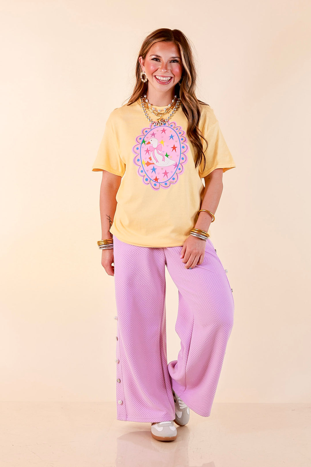 Goose on the Loose Whimsical Pink Background with Stars and Hearts Goose Printed Graphic Tee in Butter Yellow