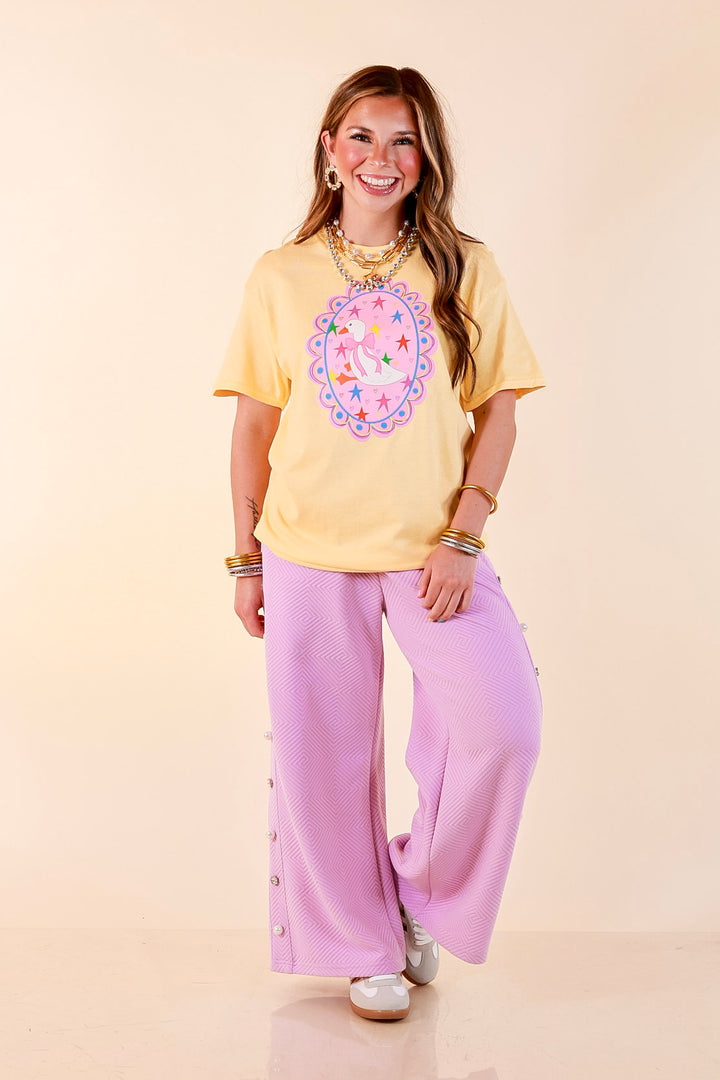 Goose on the Loose Whimsical Pink Background with Stars and Hearts Goose Printed Graphic Tee in Butter Yellow