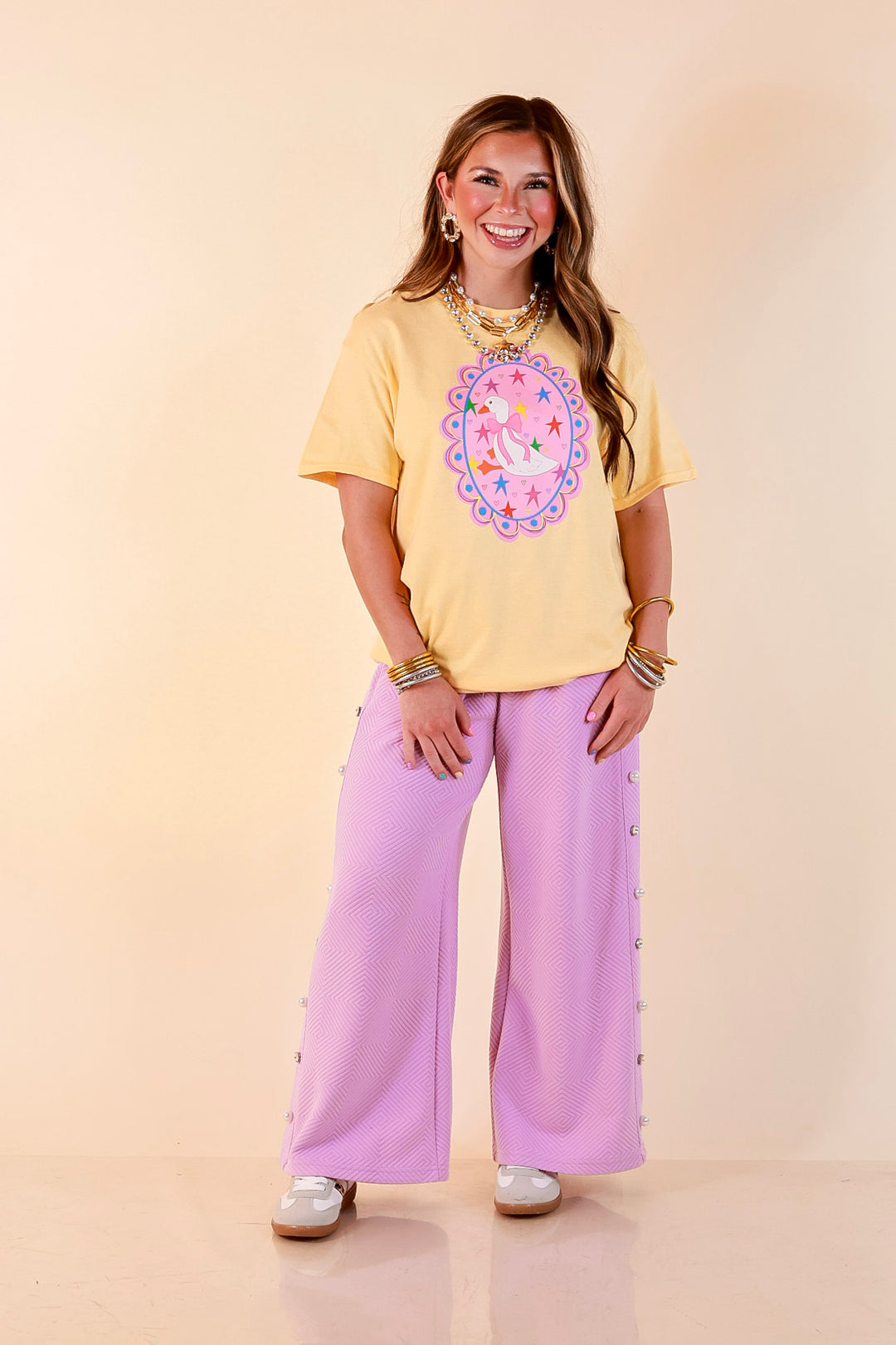 Goose on the Loose Whimsical Pink Background with Stars and Hearts Goose Printed Graphic Tee in Butter Yellow