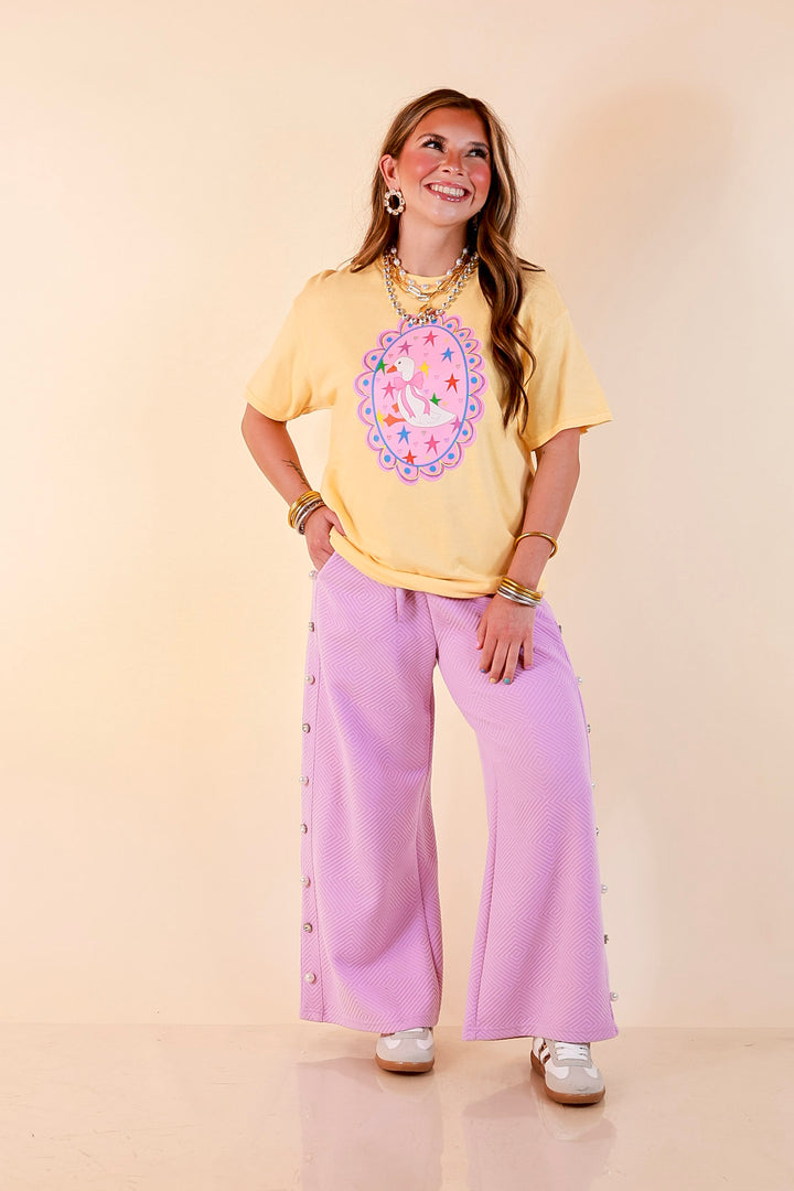 Goose on the Loose Whimsical Pink Background with Stars and Hearts Goose Printed Graphic Tee in Butter Yellow
